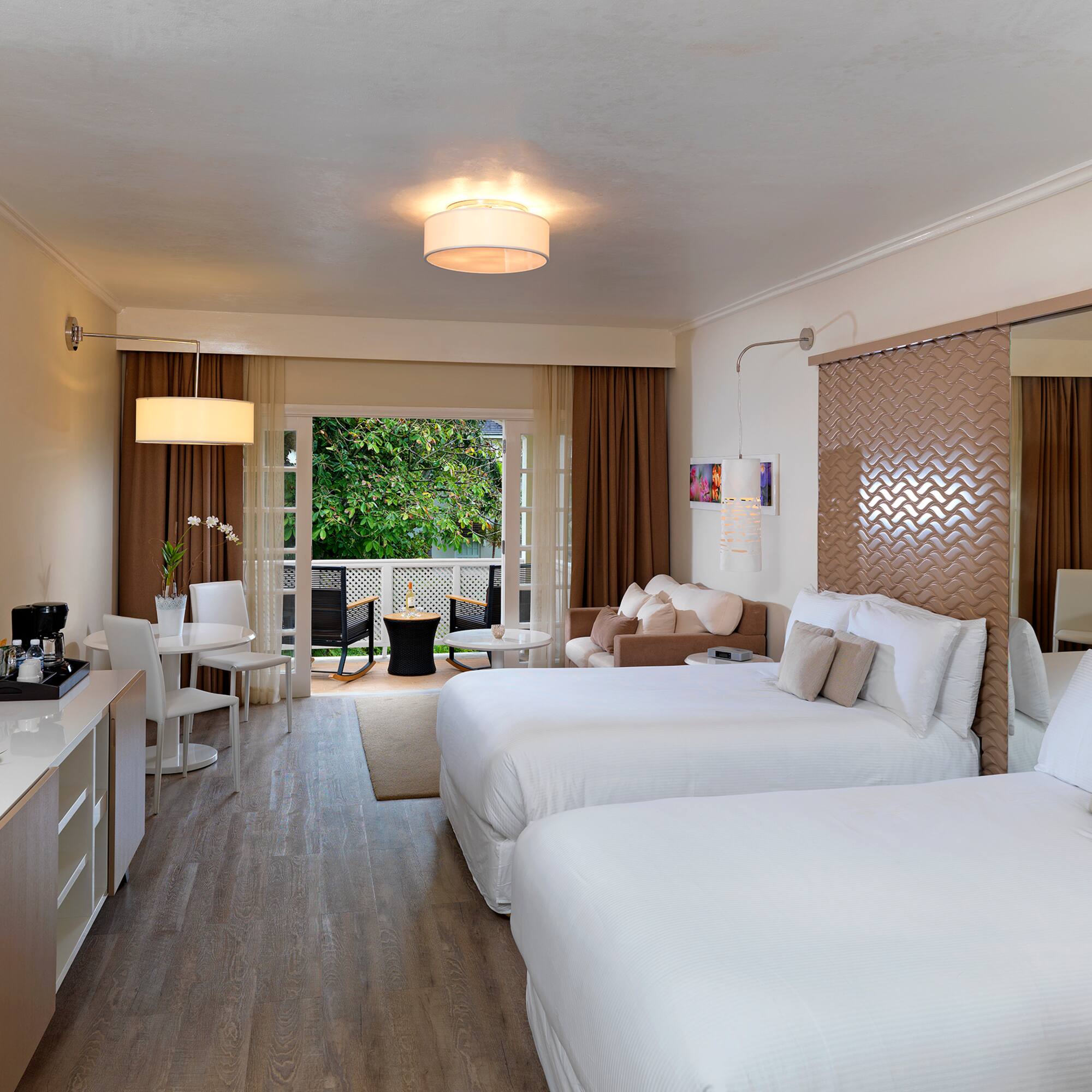 a room with two beds and a mirror