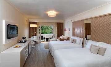 a room with two beds and a mirror