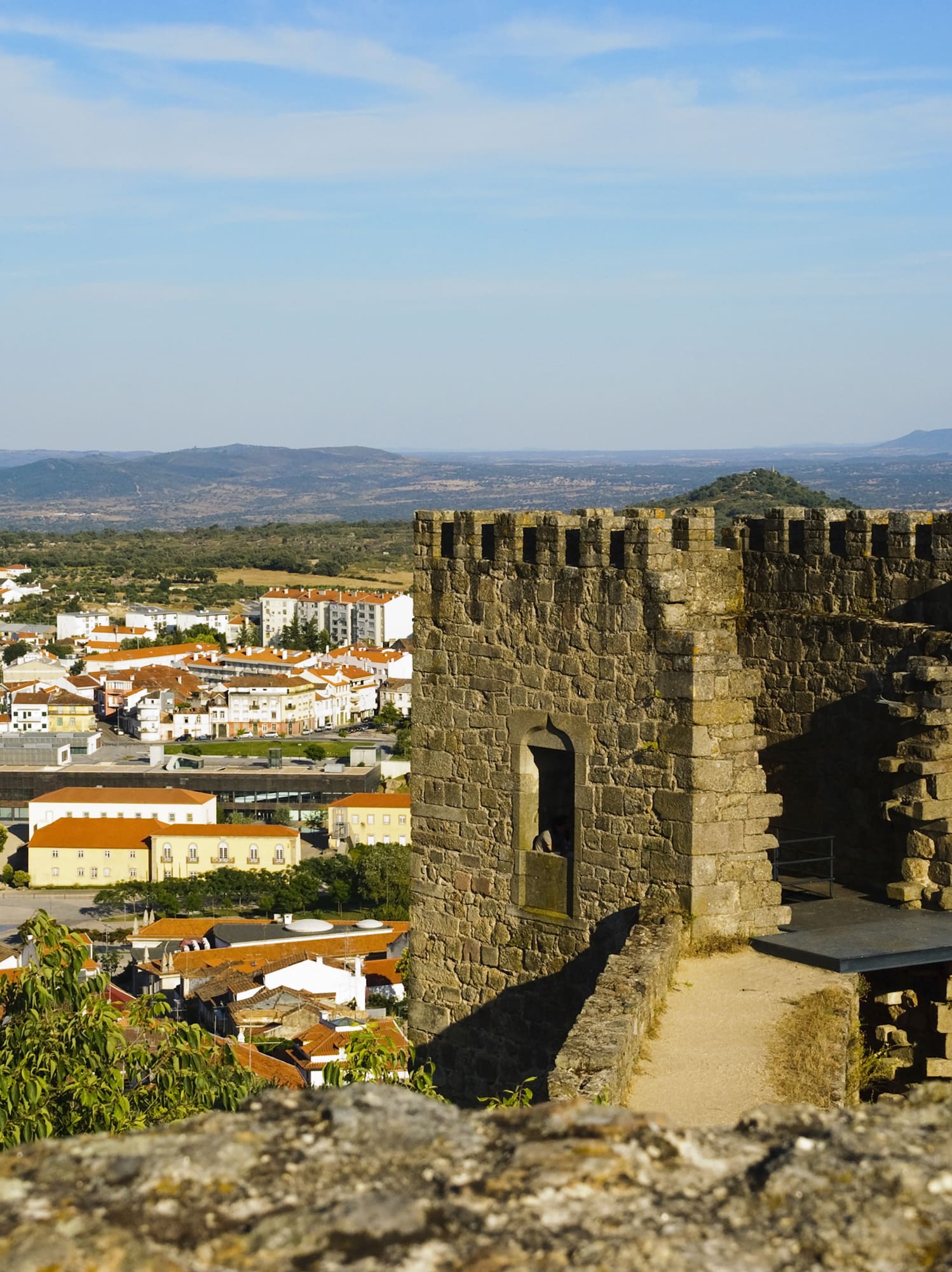 a stone tower with a city in the background