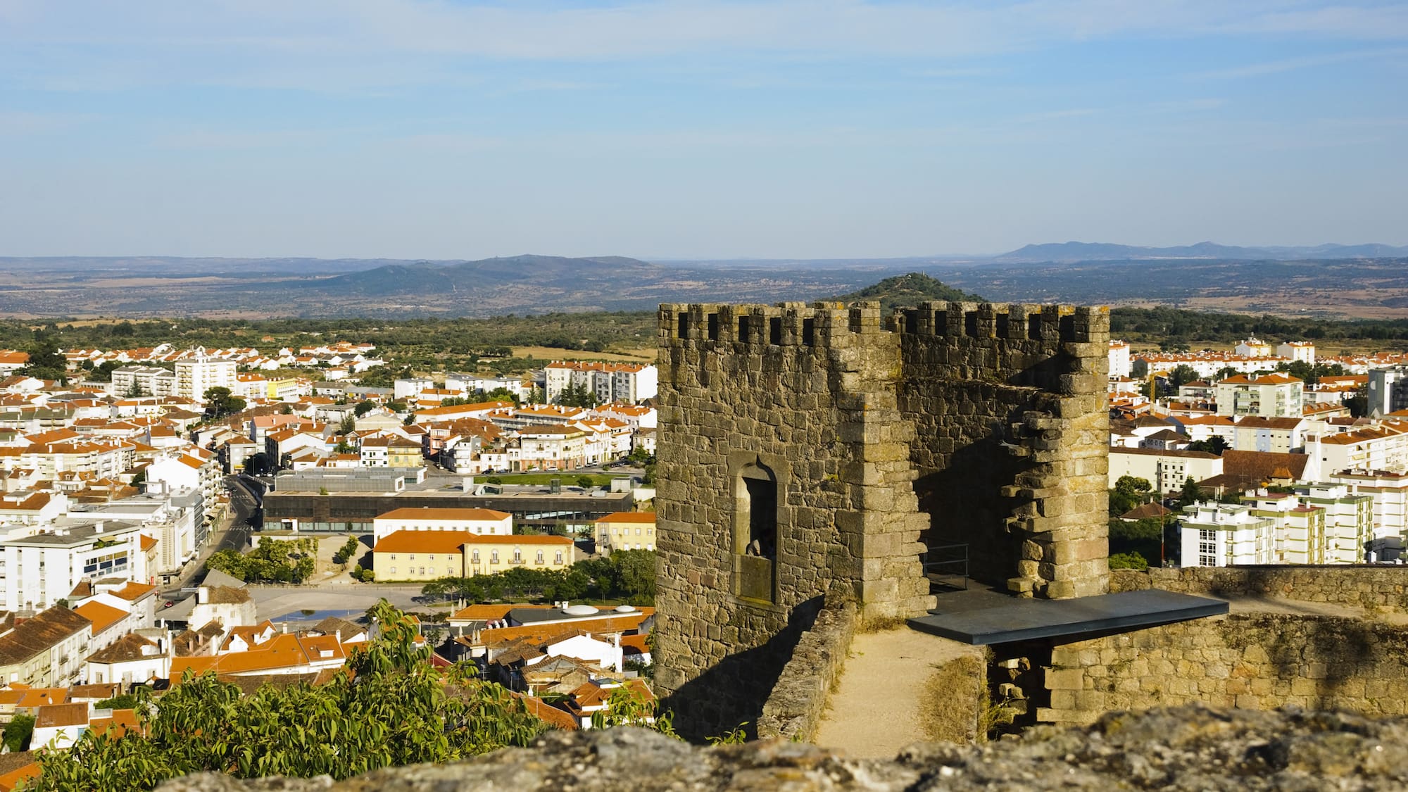 a stone tower with a city in the background