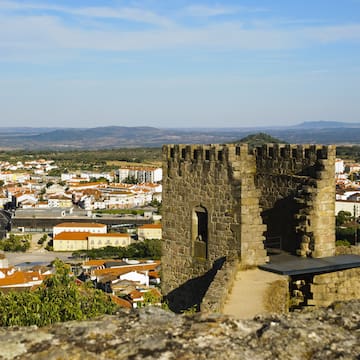 a stone tower with a city in the background