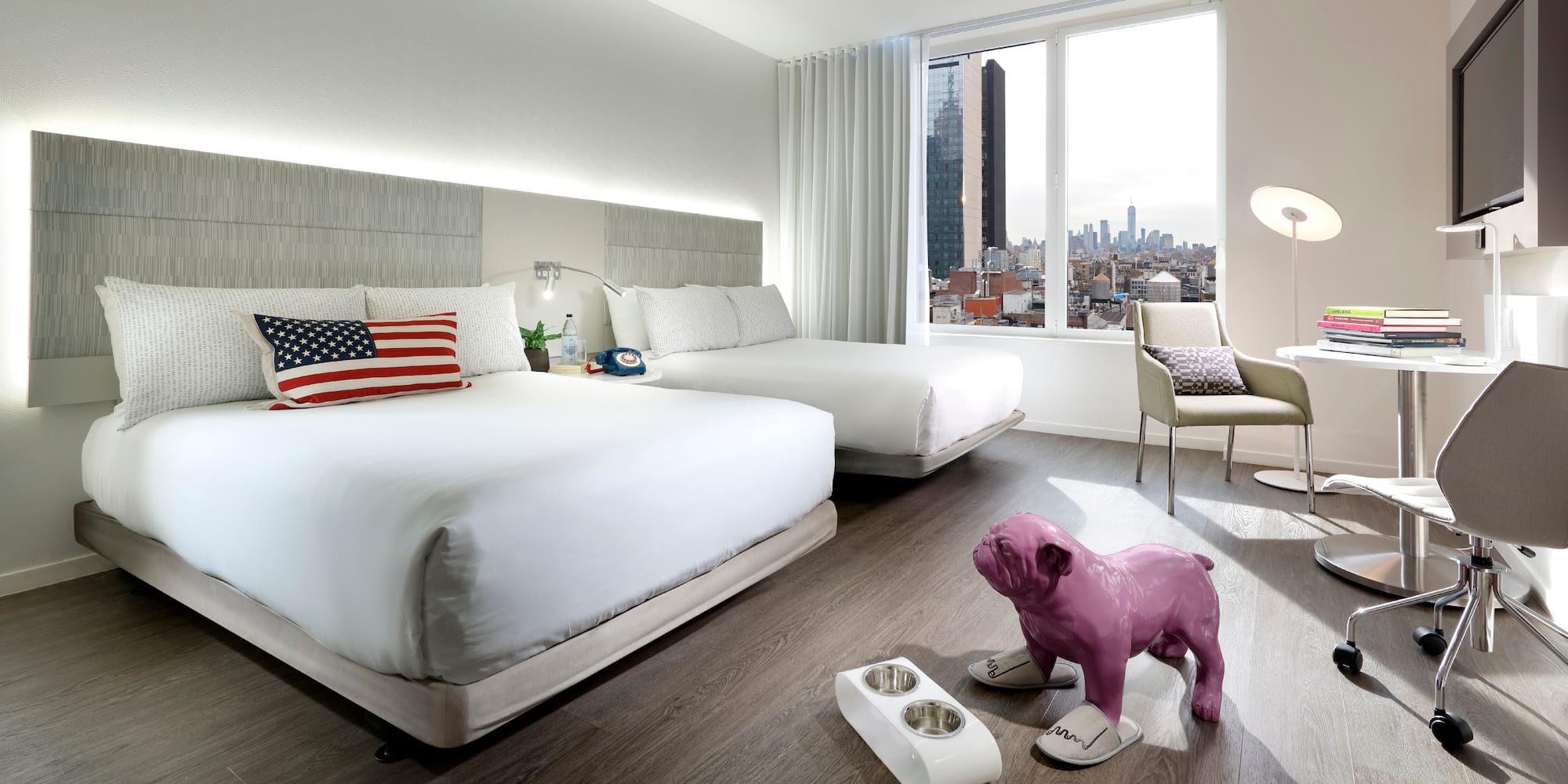 a bedroom with a dog statue and a table