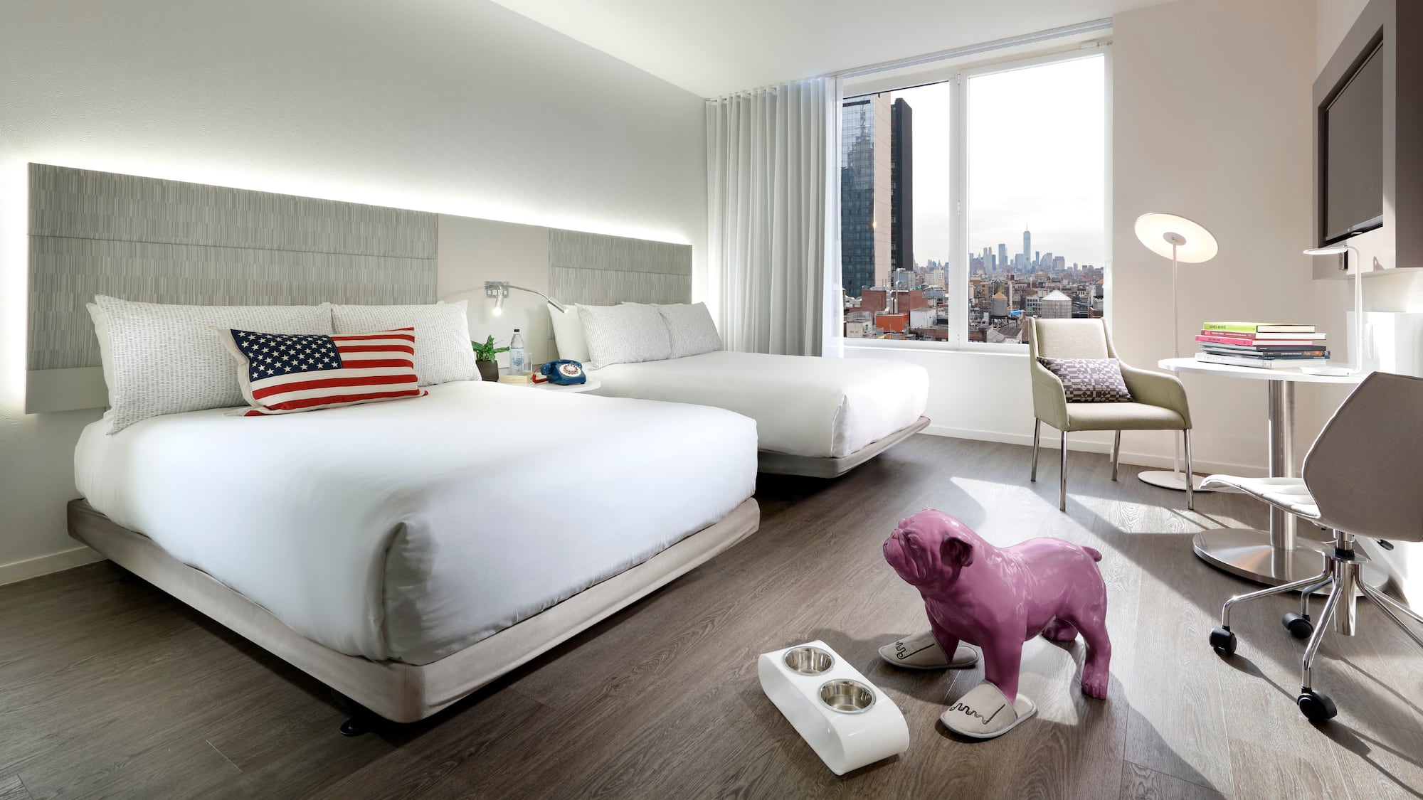 a bedroom with a dog statue and a table