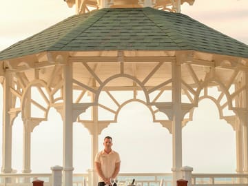a man standing in front of a gazebo