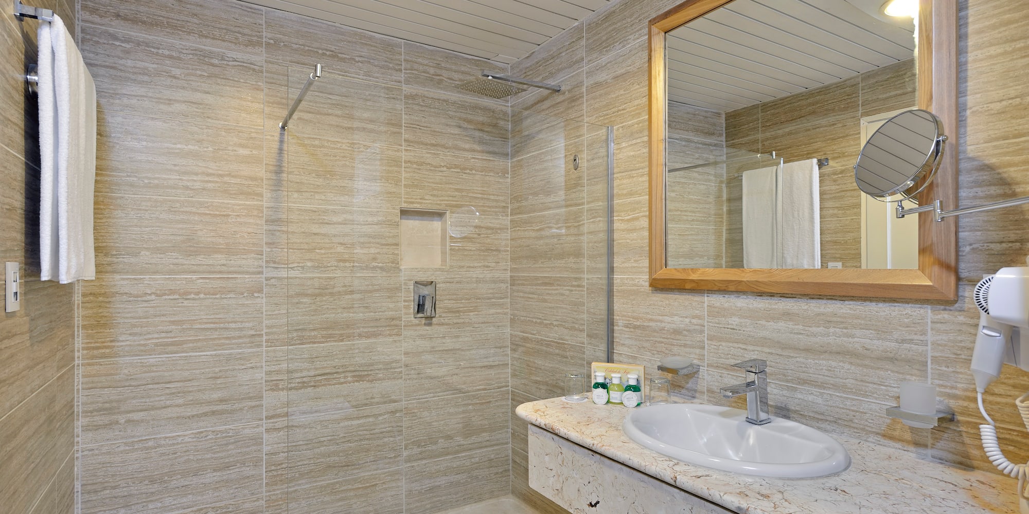a bathroom with a marble countertop sink and mirror