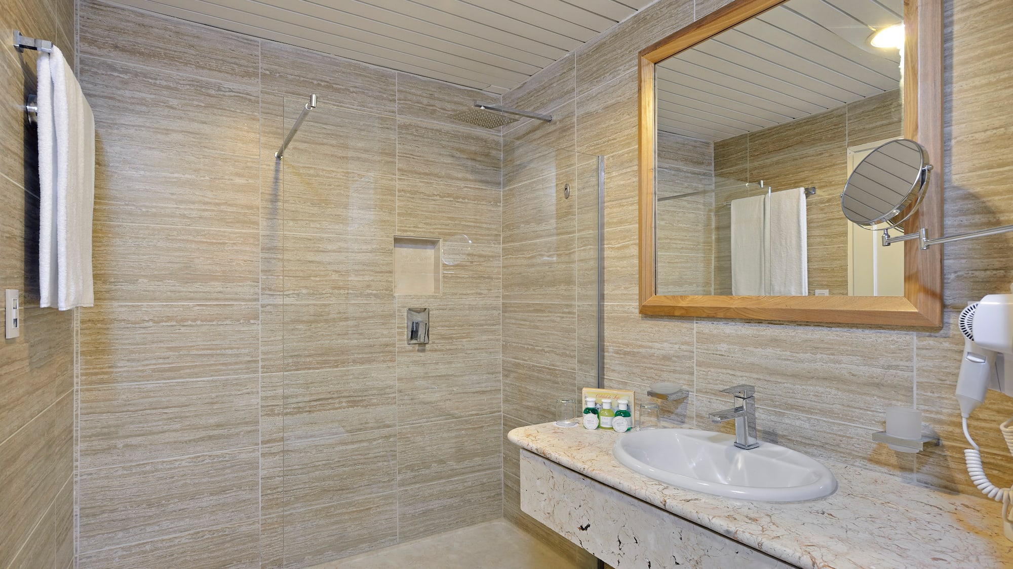 a bathroom with a marble countertop sink and mirror