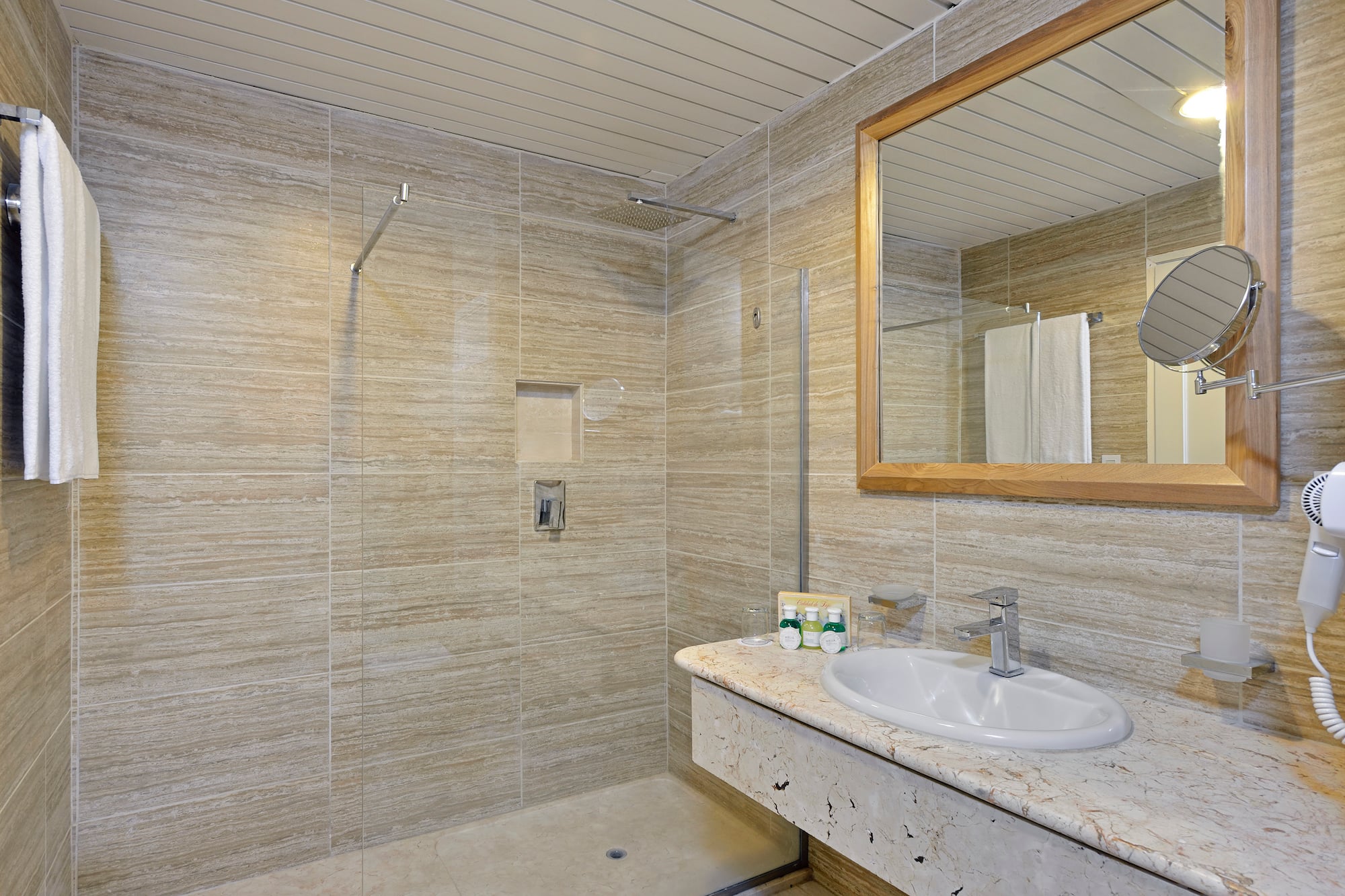 a bathroom with a marble countertop sink and mirror
