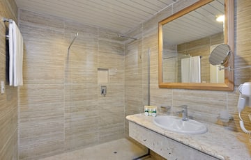 a bathroom with a marble countertop sink and mirror