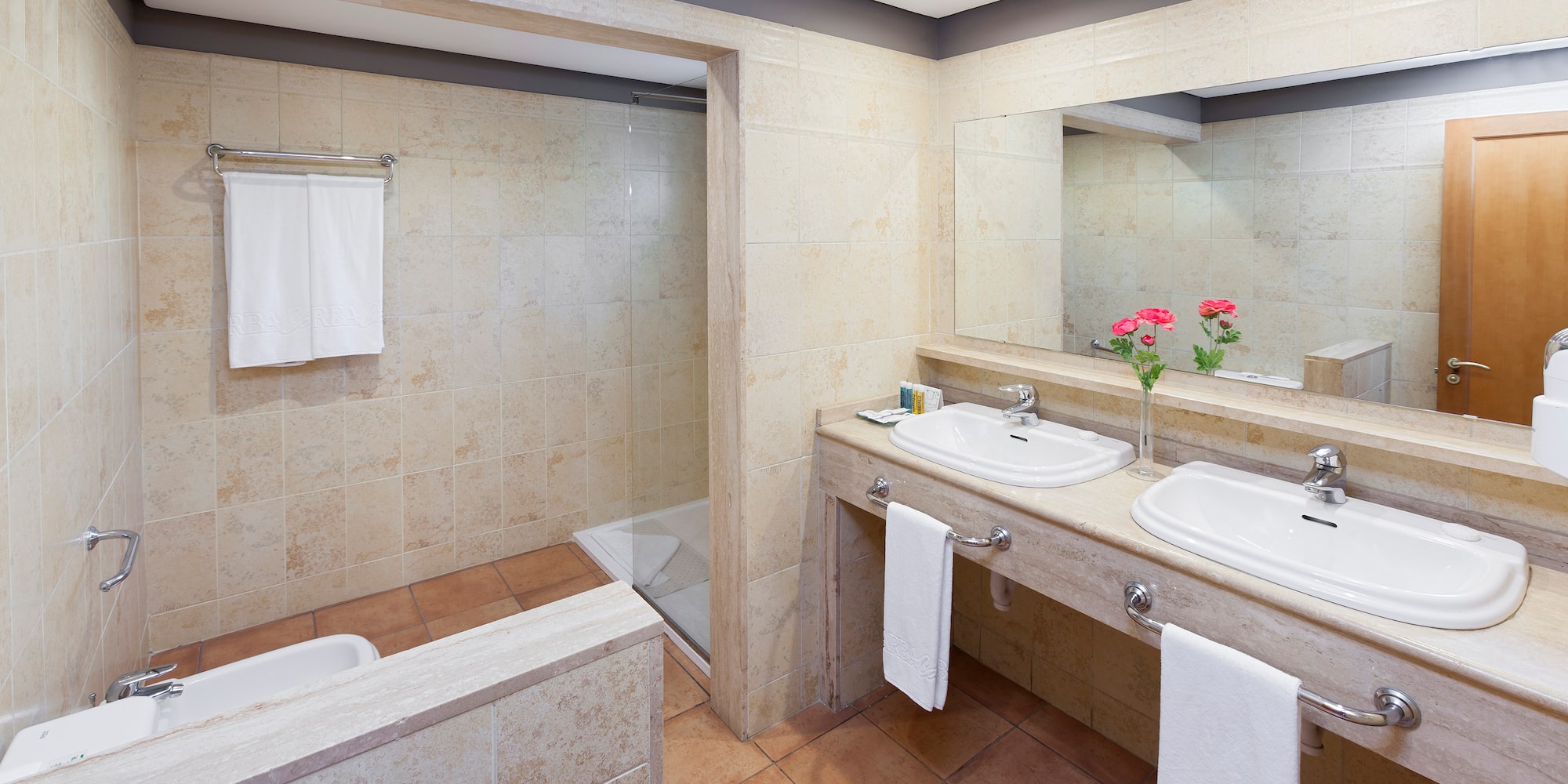 a bathroom with two sinks and a shower