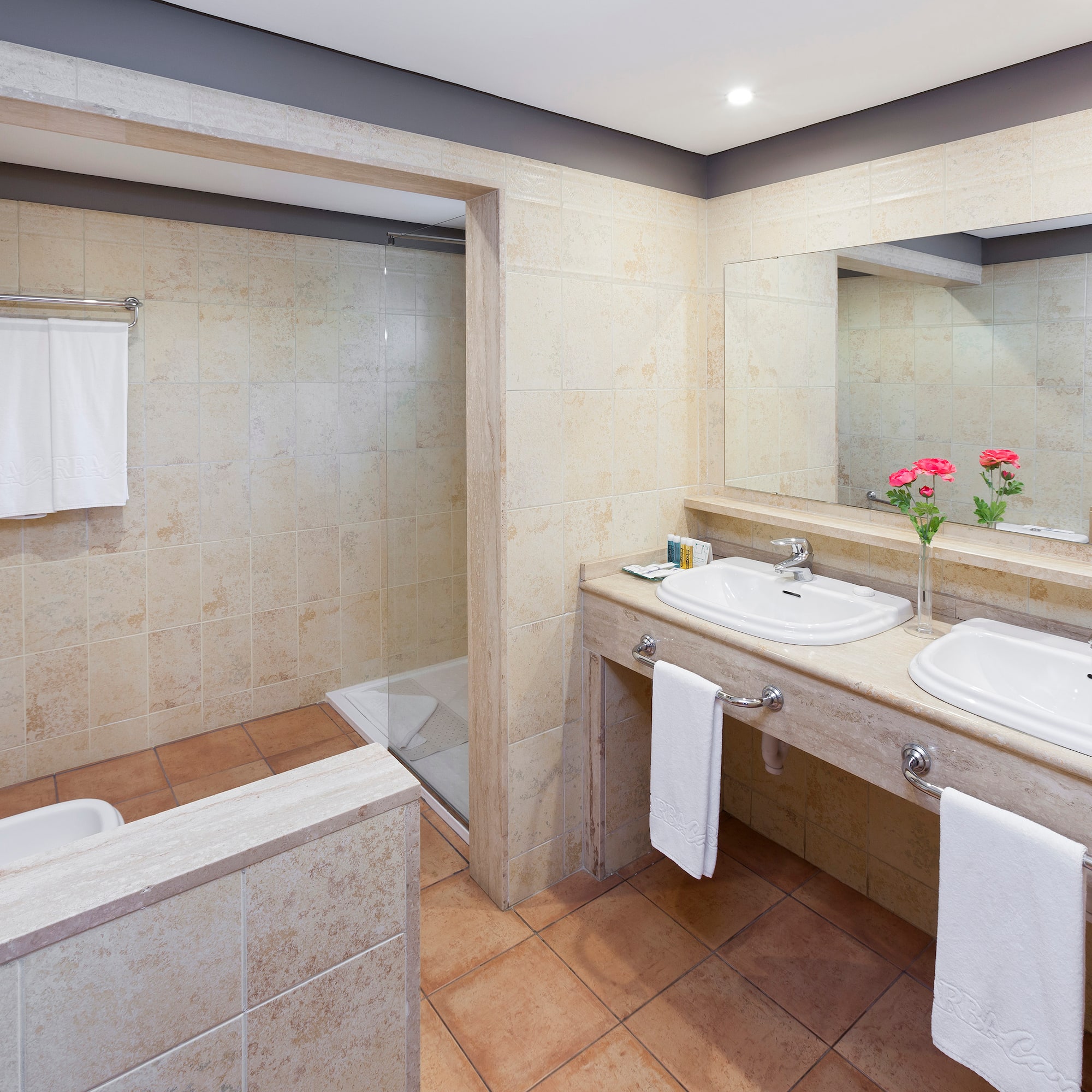 a bathroom with two sinks and a shower