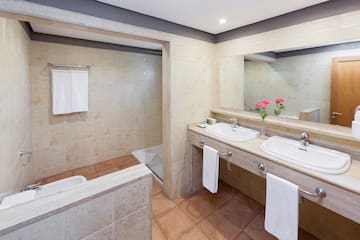 a bathroom with two sinks and a shower