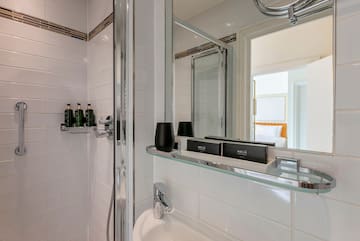 a bathroom with a glass shelf