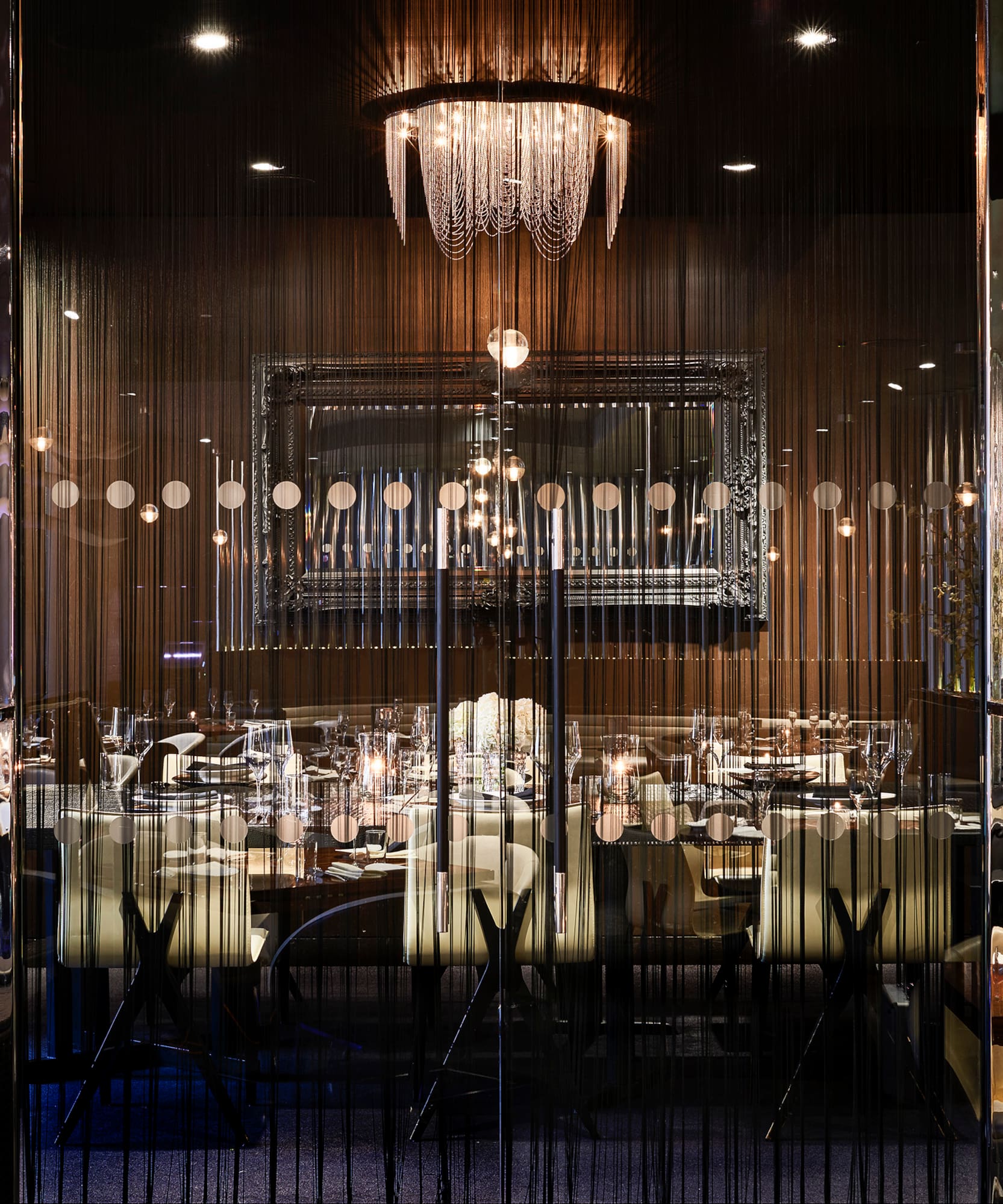a room with a chandelier and tables