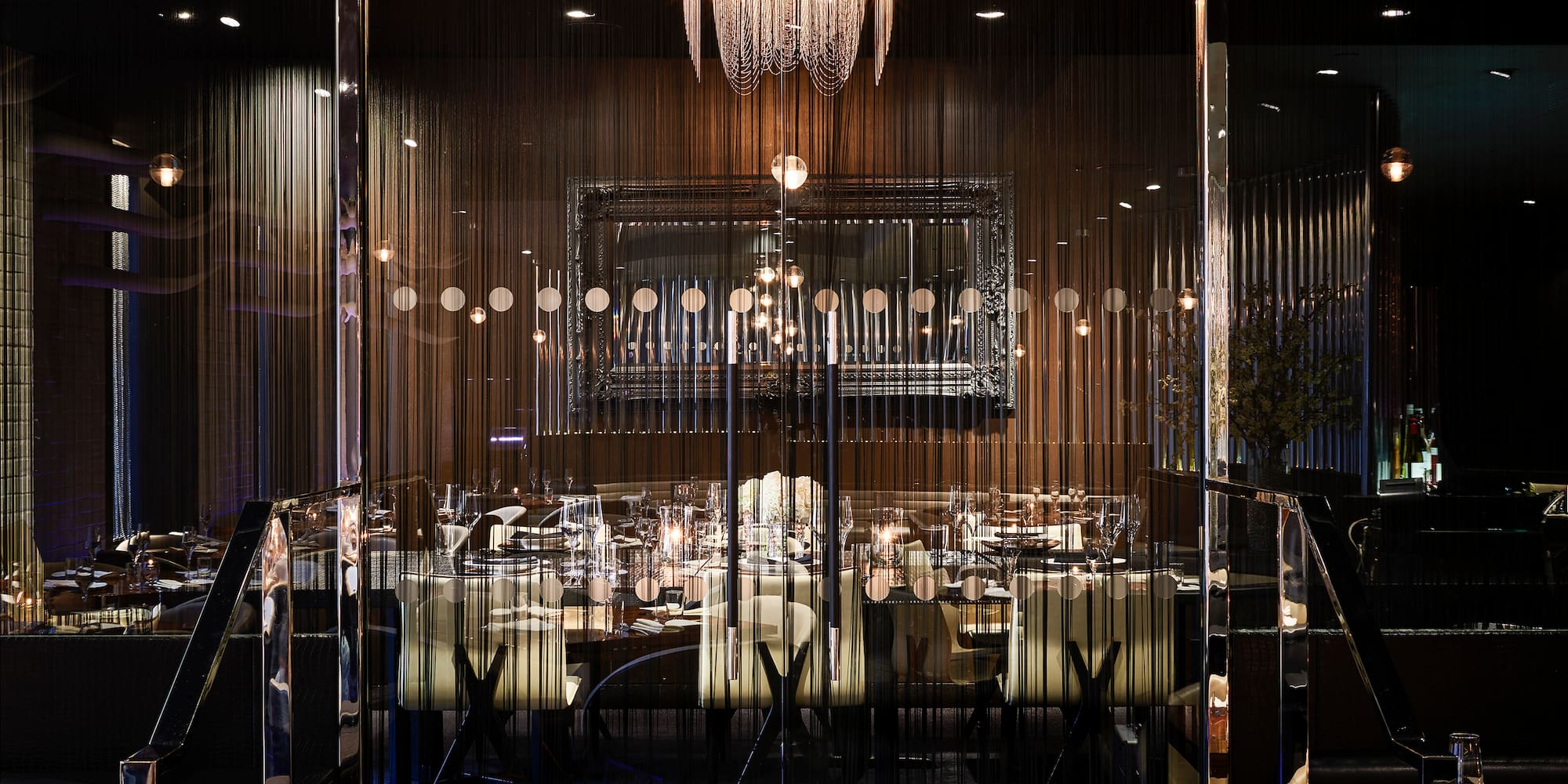 a room with a chandelier and tables