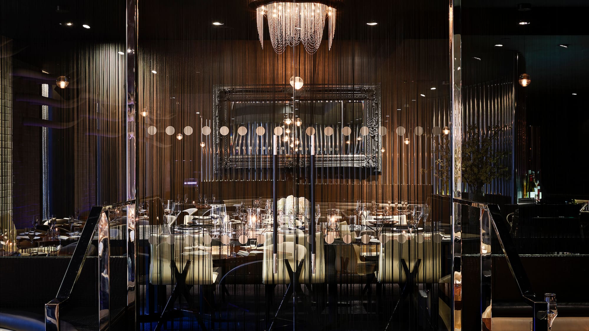 a room with a chandelier and tables