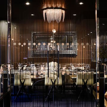 a room with a chandelier and tables