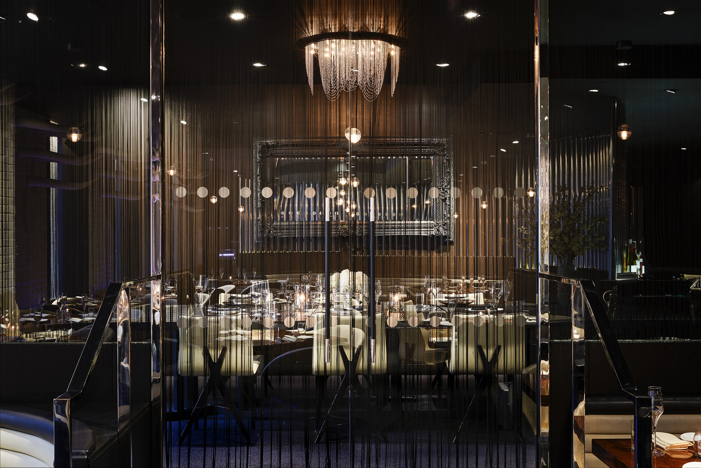 a room with a chandelier and tables