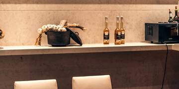 a table with white chairs and a blackboard on the wall