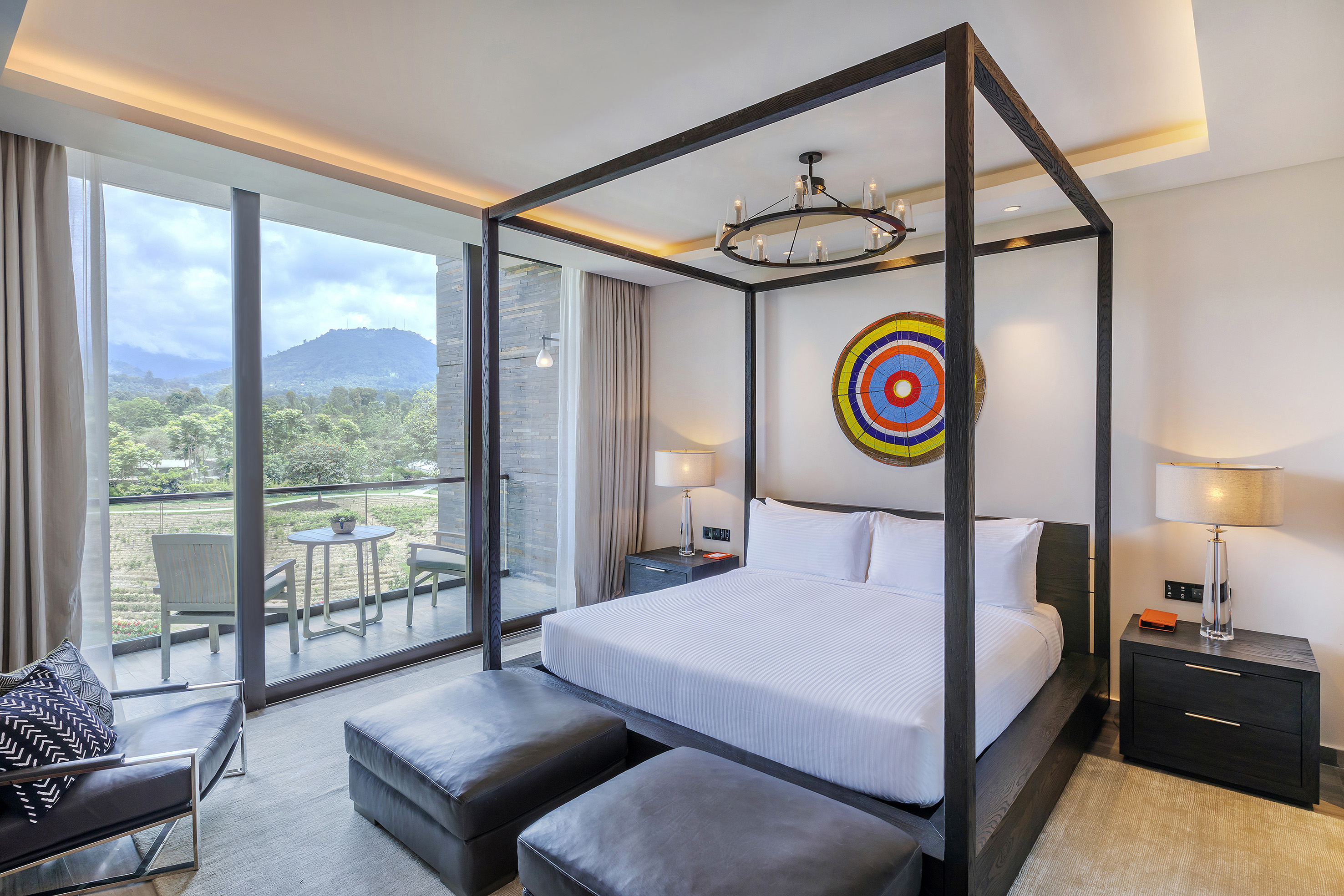 a bed with a four poster bed and a chair