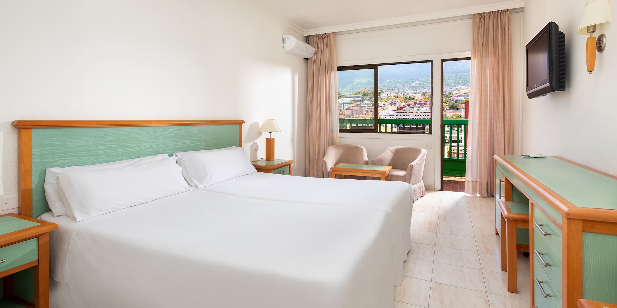 a room with two beds and a window