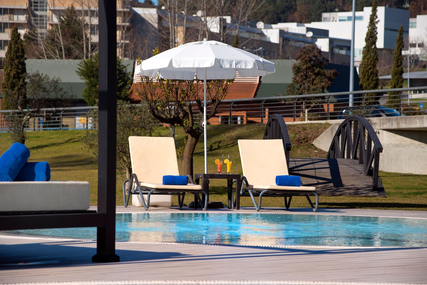 a pool with chairs and umbrella