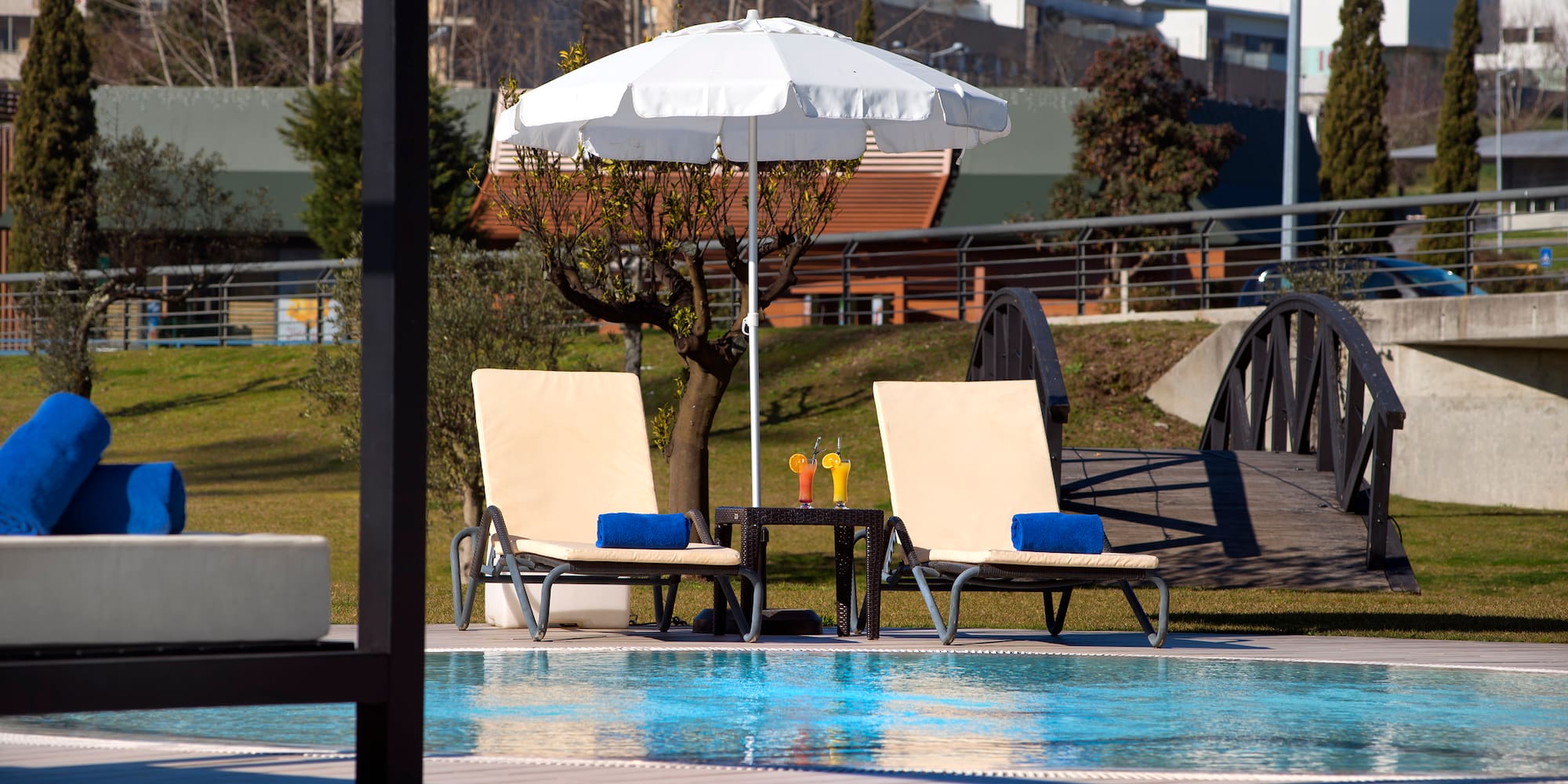 a pool with chairs and umbrella