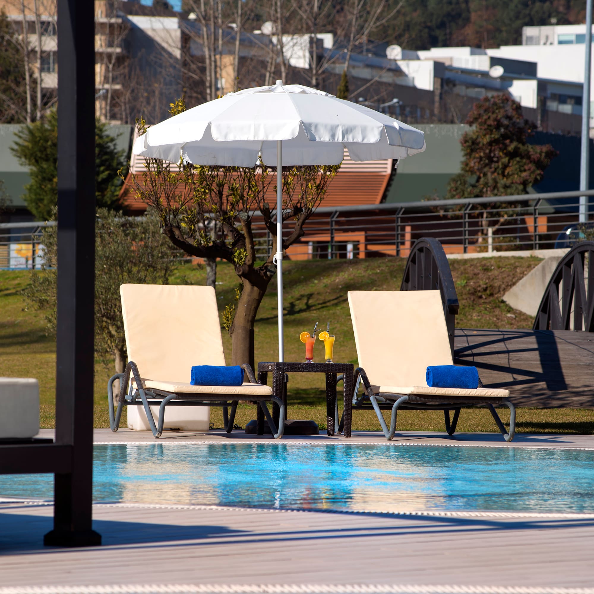 a pool with chairs and umbrella