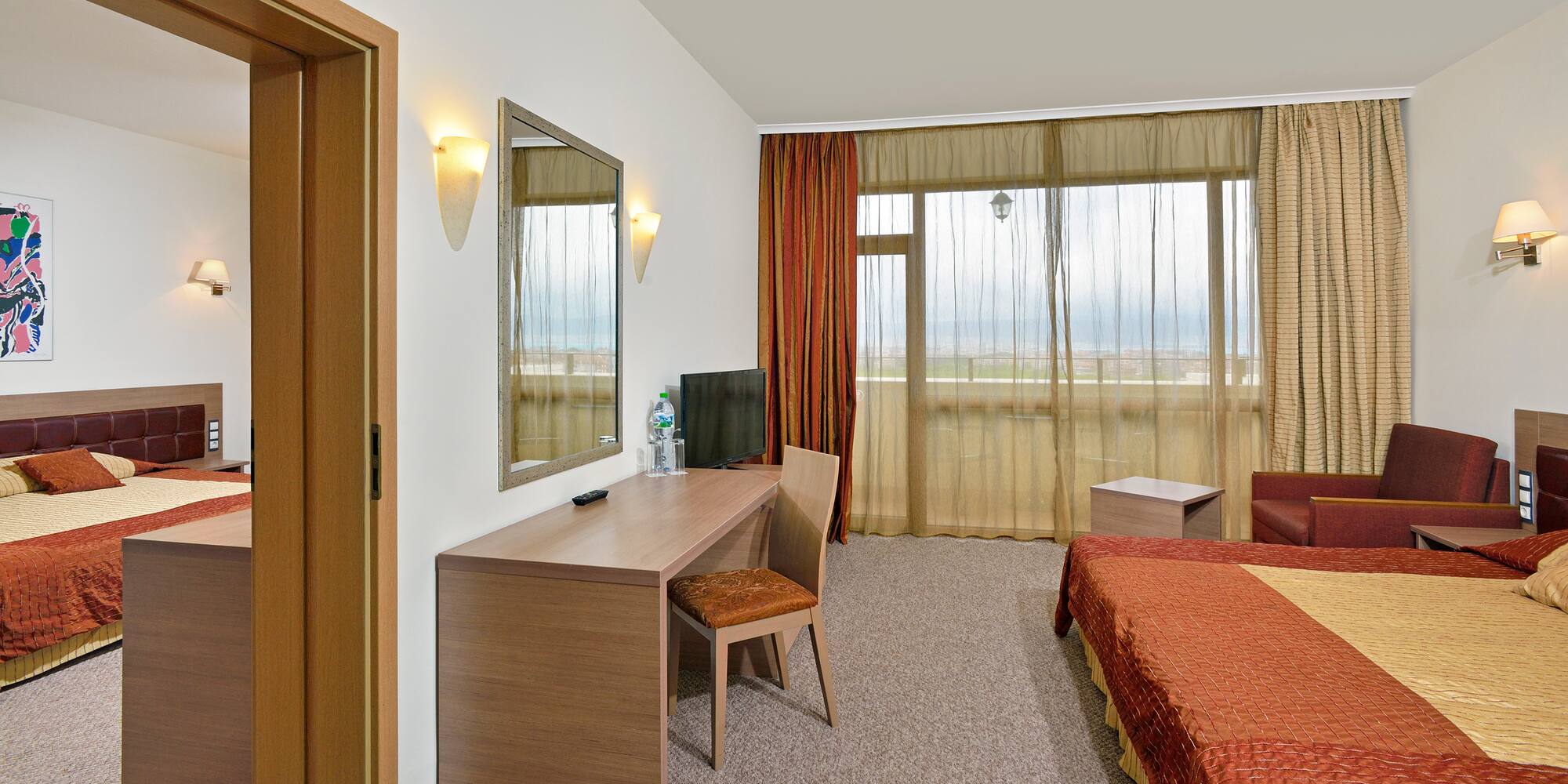 a room with a bed and a mirror