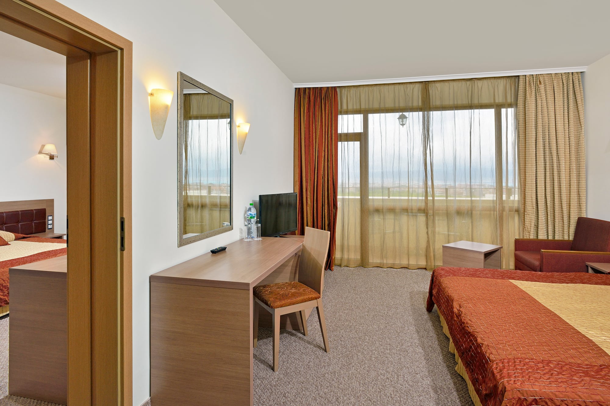 a room with a bed and a mirror