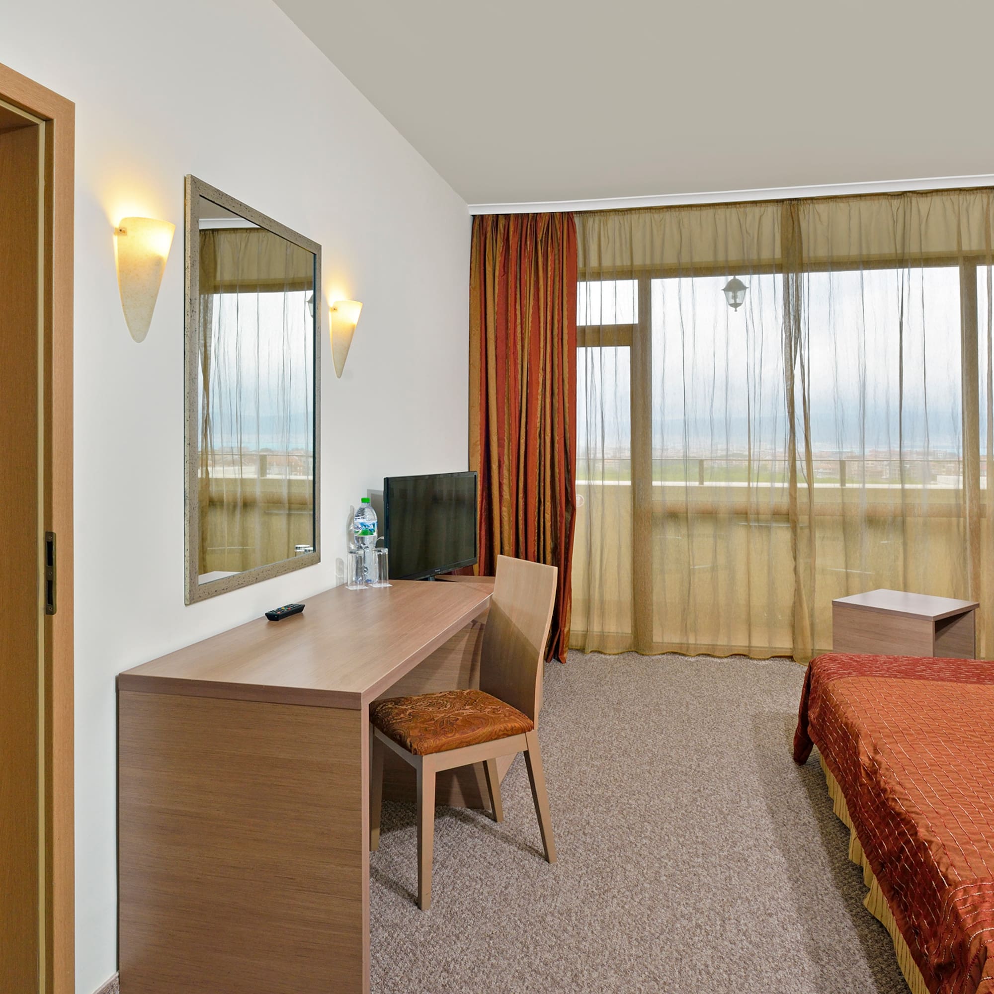 a room with a bed and a mirror