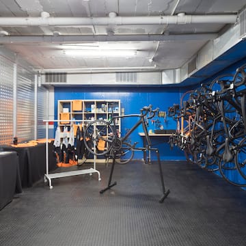 a room with a rack of bicycles