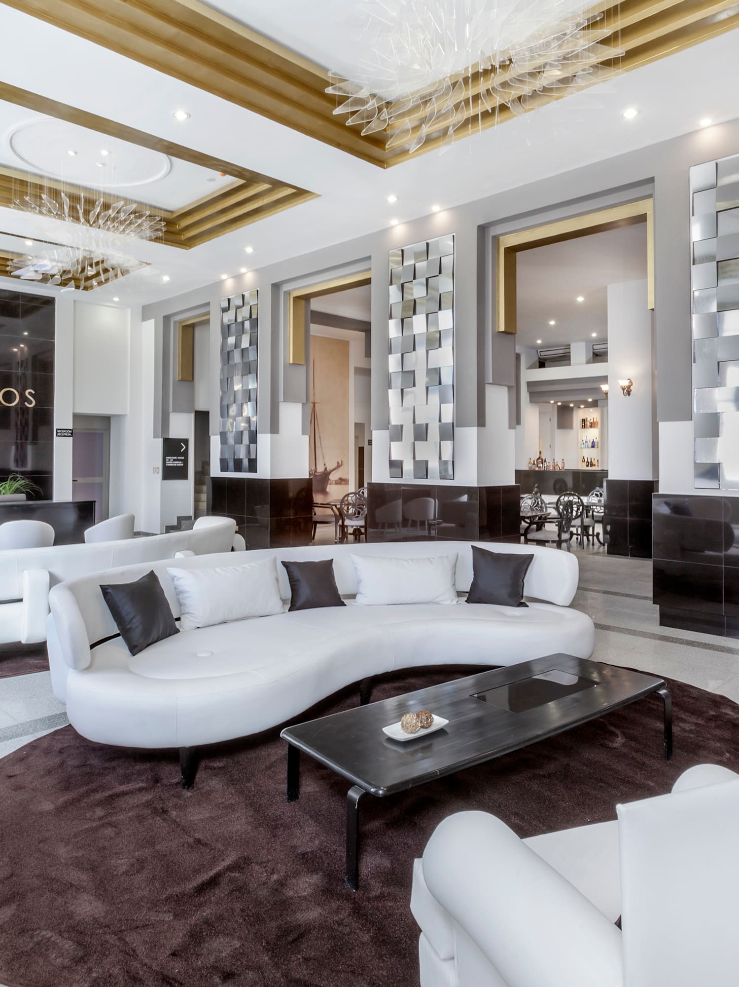 a large room with white furniture and a black table