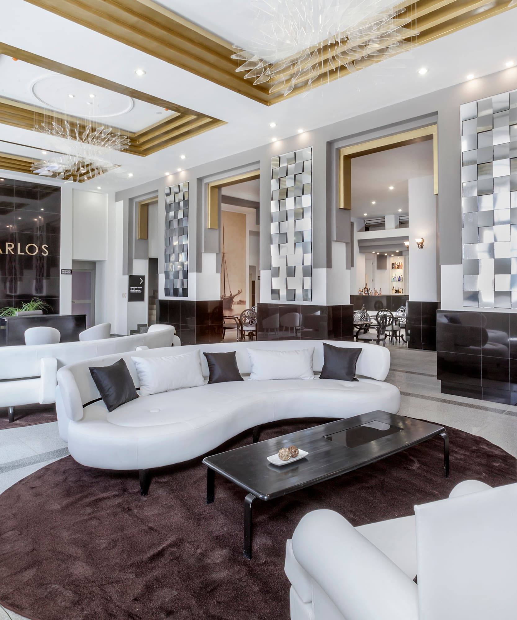 a large room with white furniture and a black table