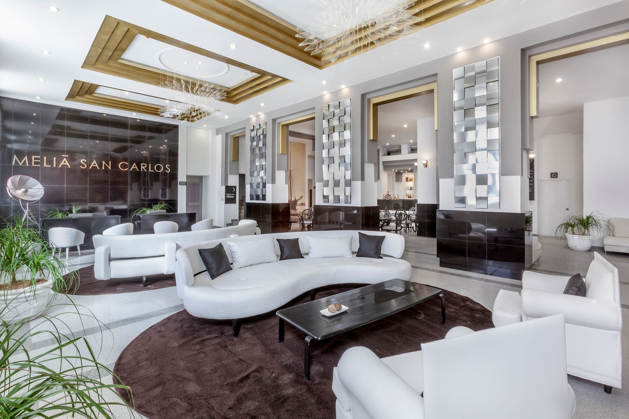 a large room with white furniture and a black table