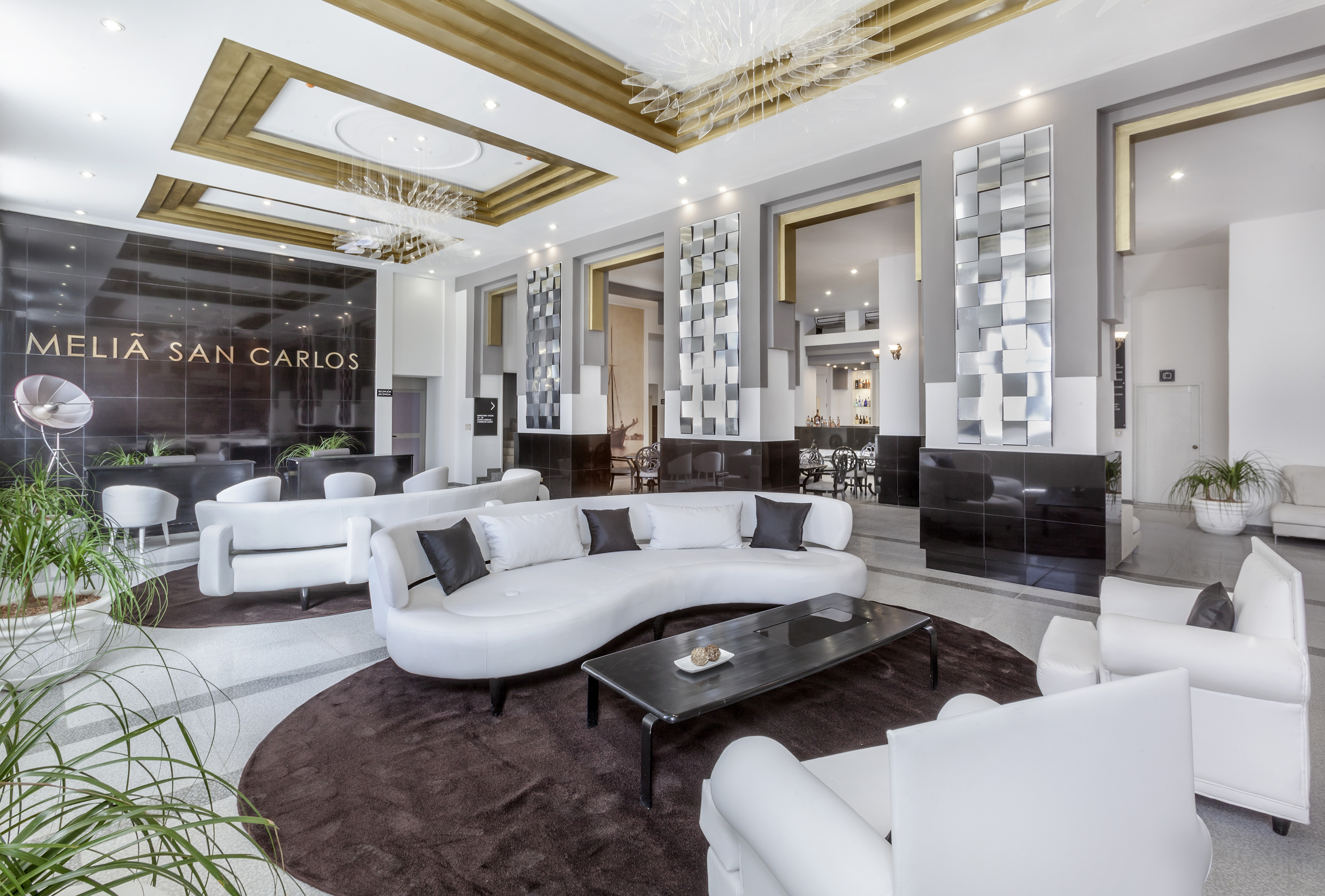 a large room with white furniture and a black table