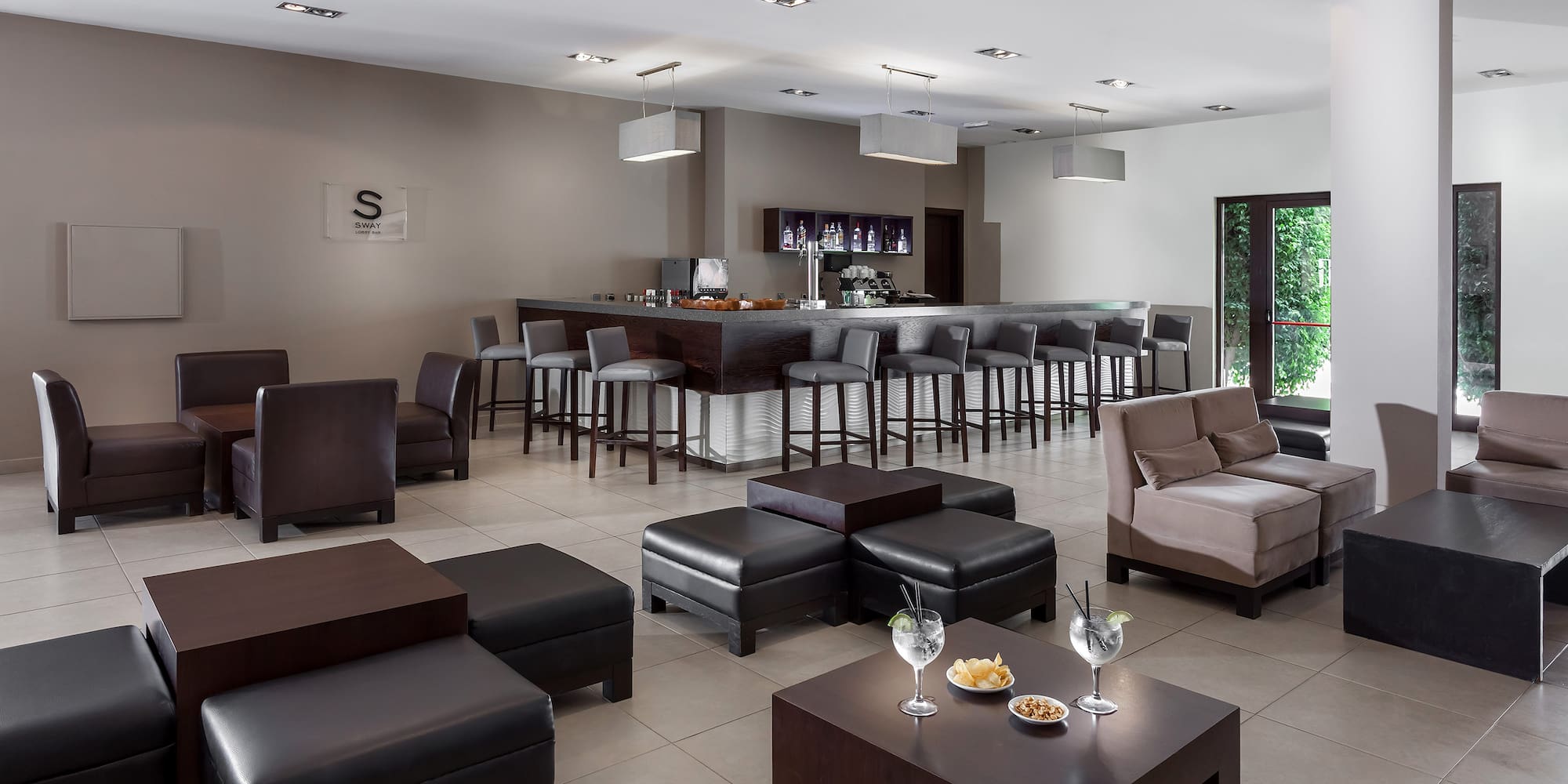 a room with a bar and chairs