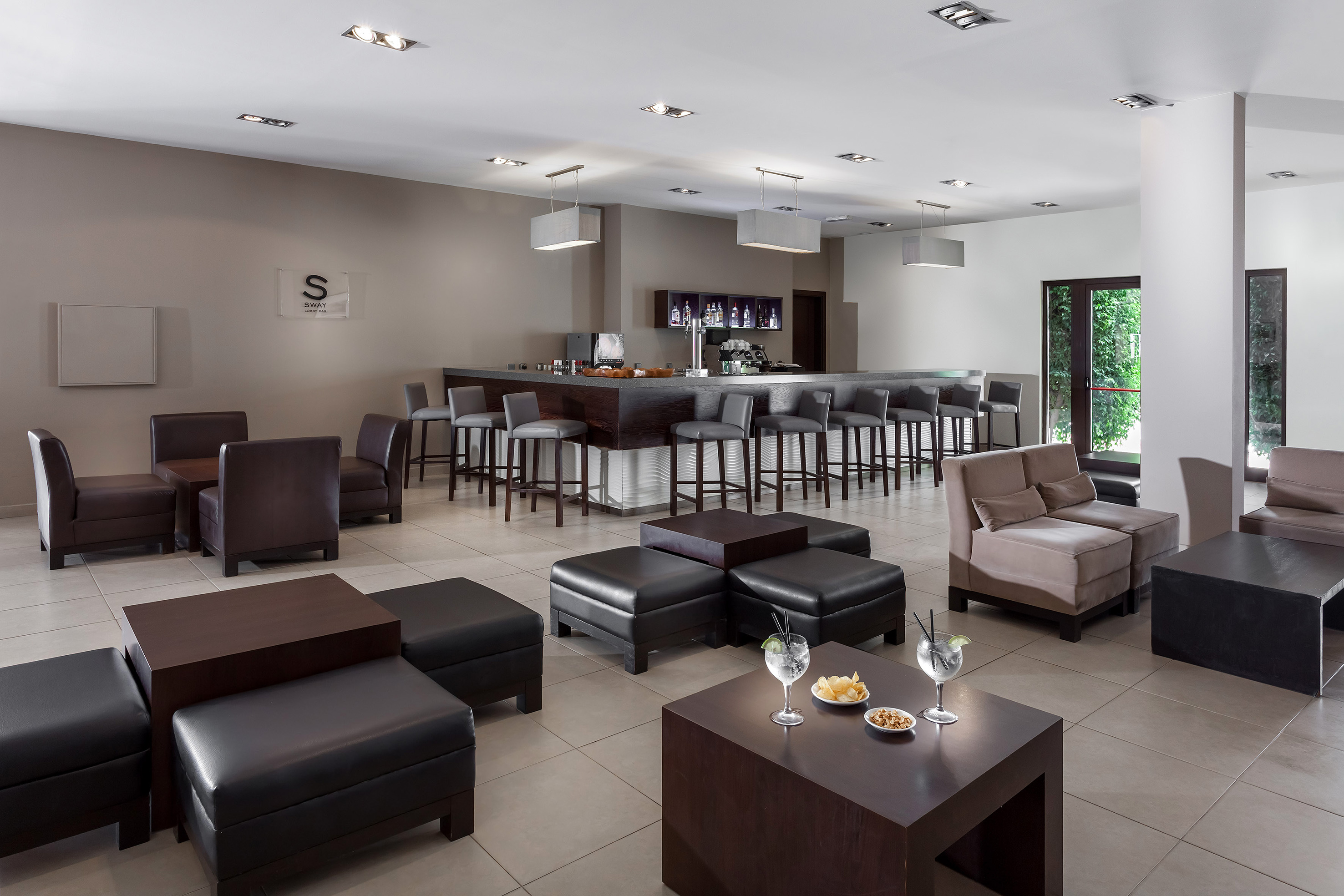 a room with a bar and chairs