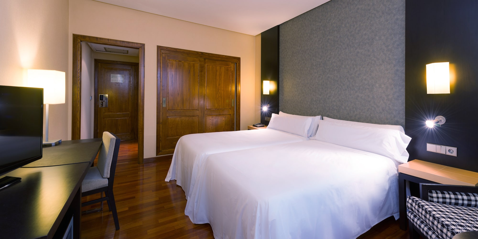 a room with two beds and a table