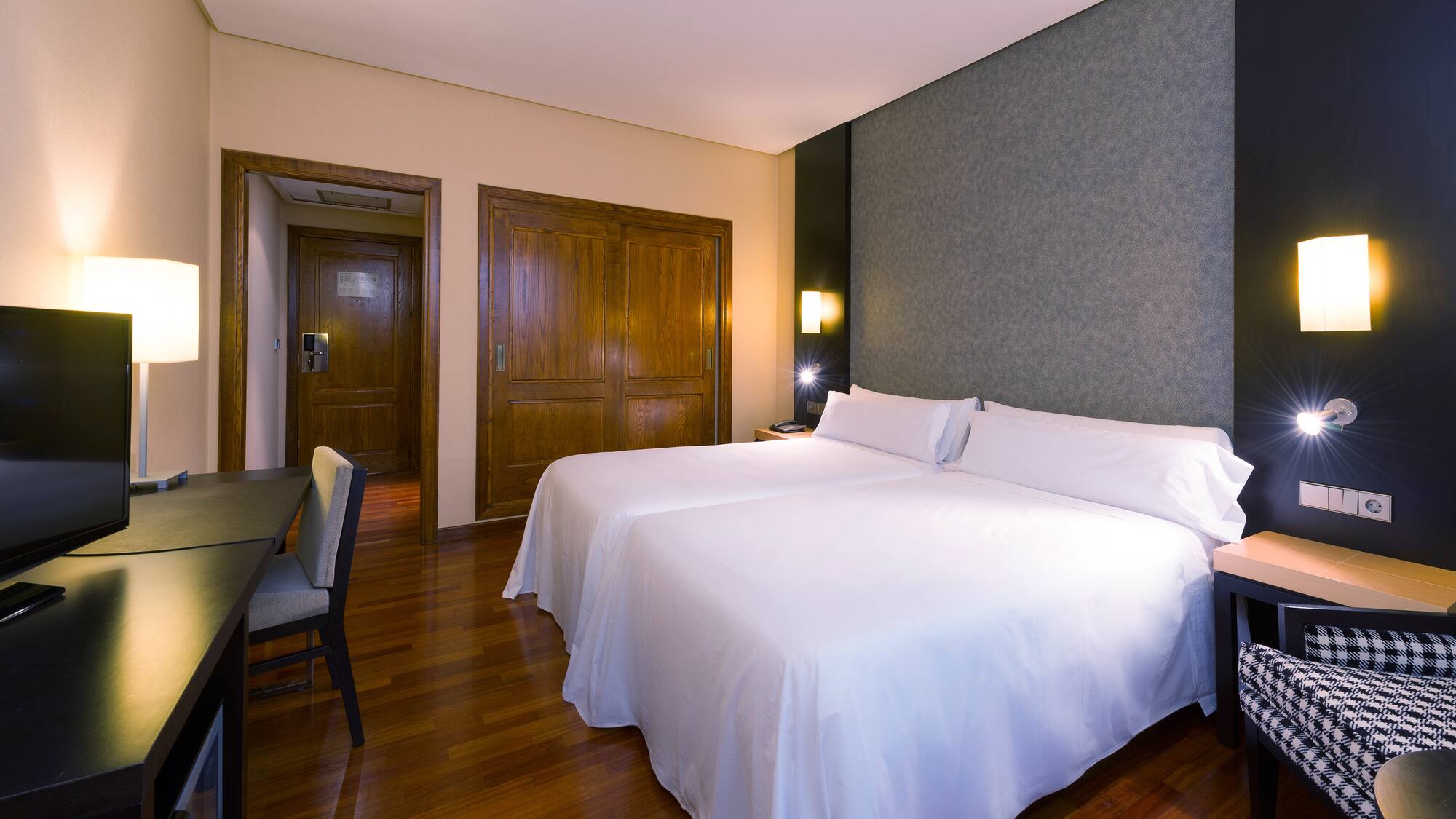 a room with two beds and a table