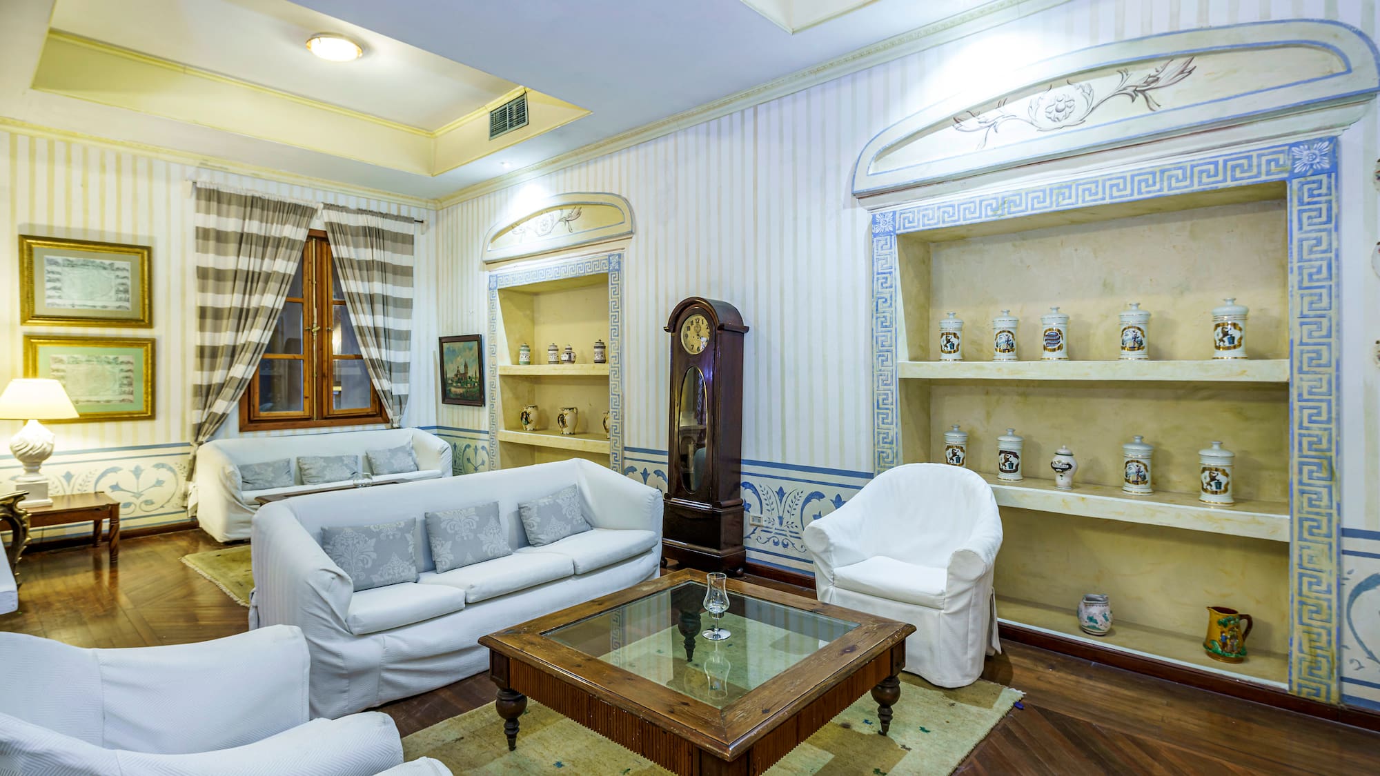 a room with white furniture and a clock