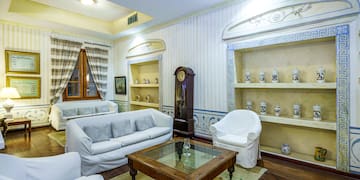 a room with white furniture and a clock