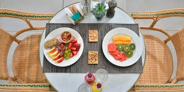 a table with plates of fruit and nuts