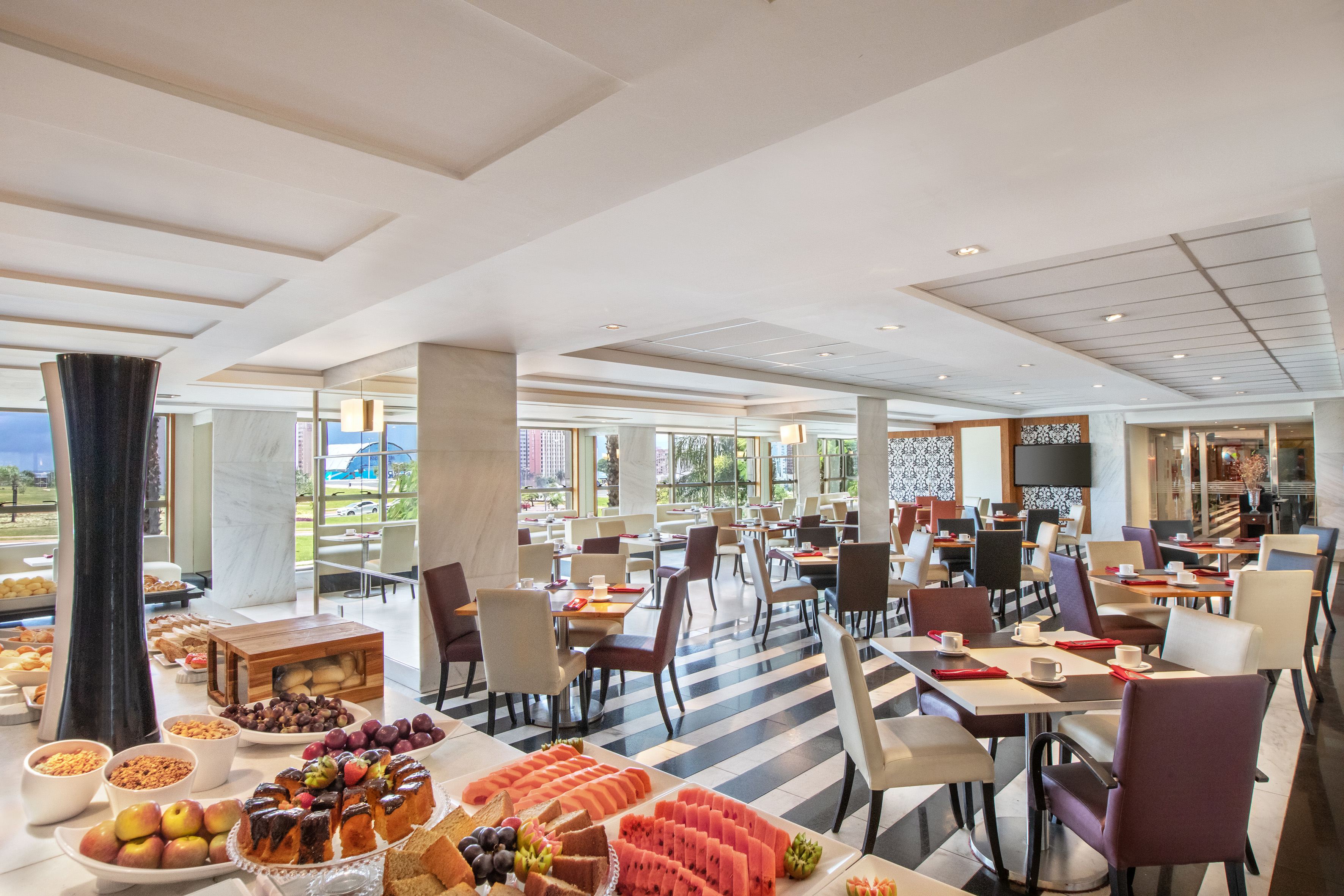 Spacious hotel buffet restaurant with varied food display and modern dining area.