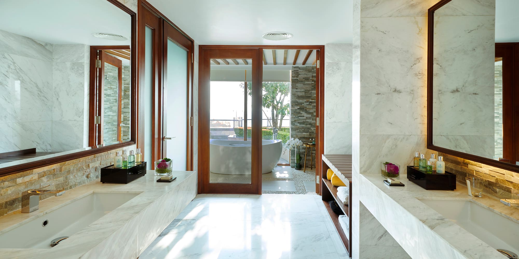 a bathroom with marble walls and a tub