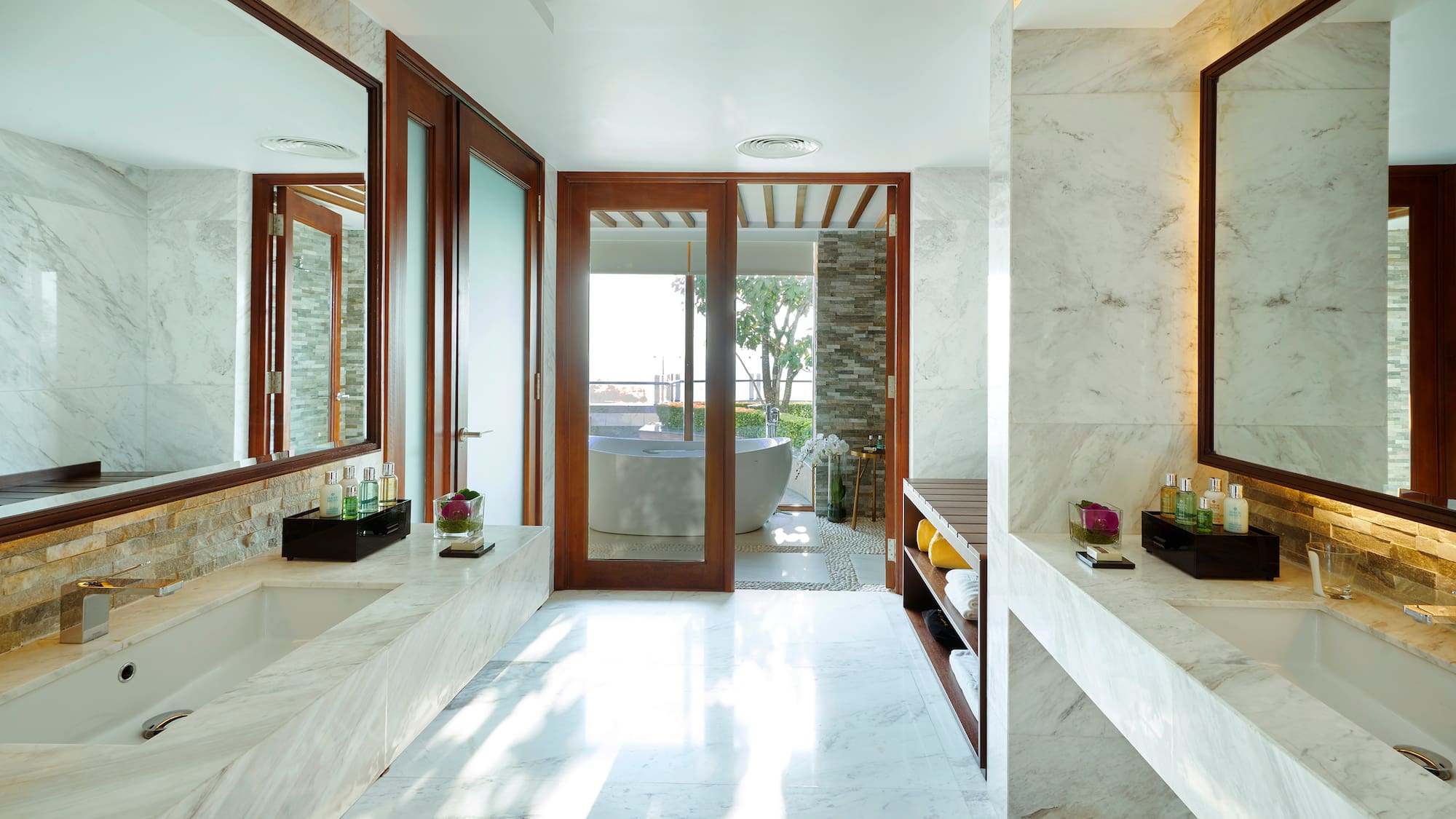a bathroom with marble walls and a tub