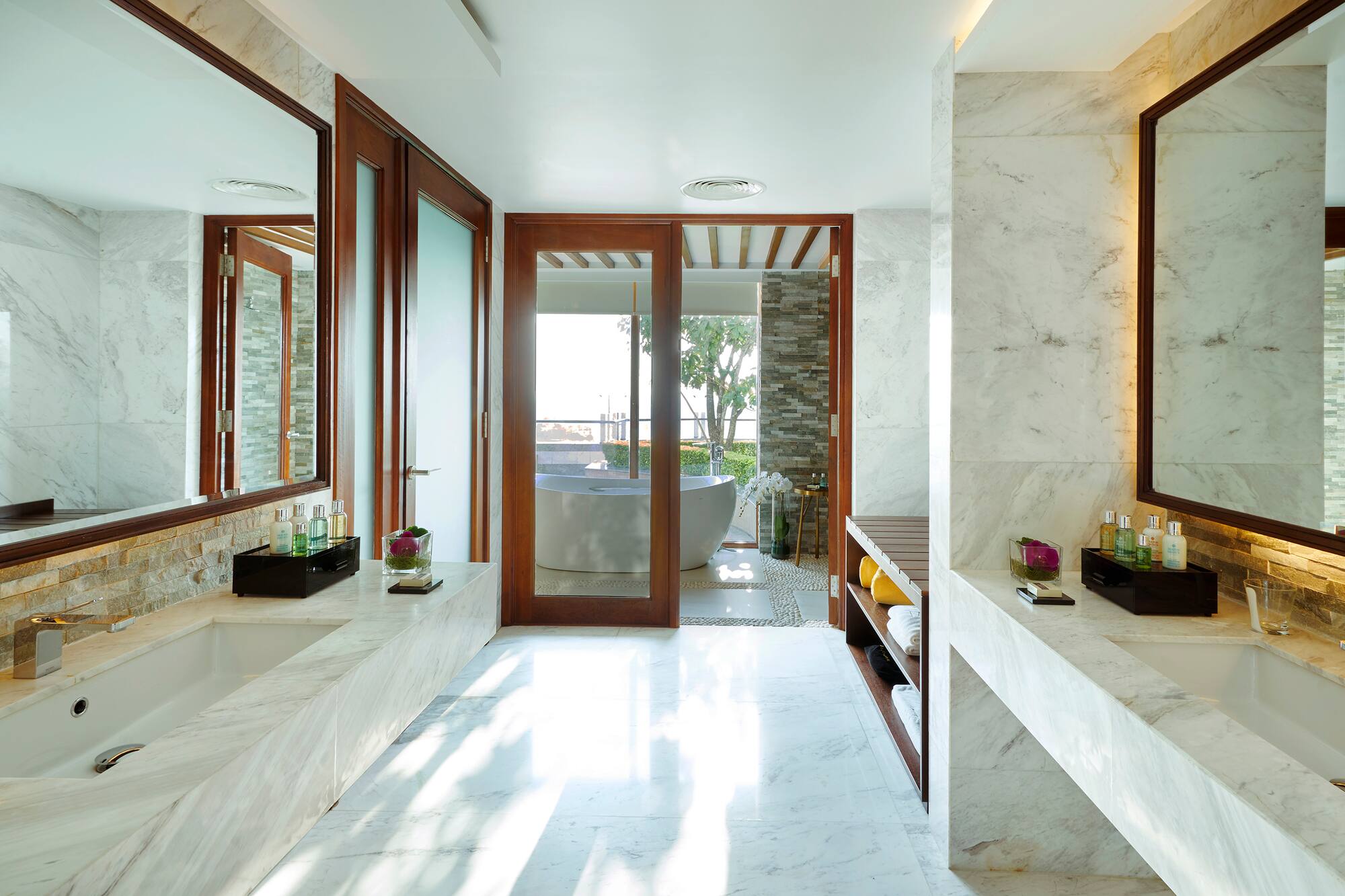a bathroom with marble walls and a tub