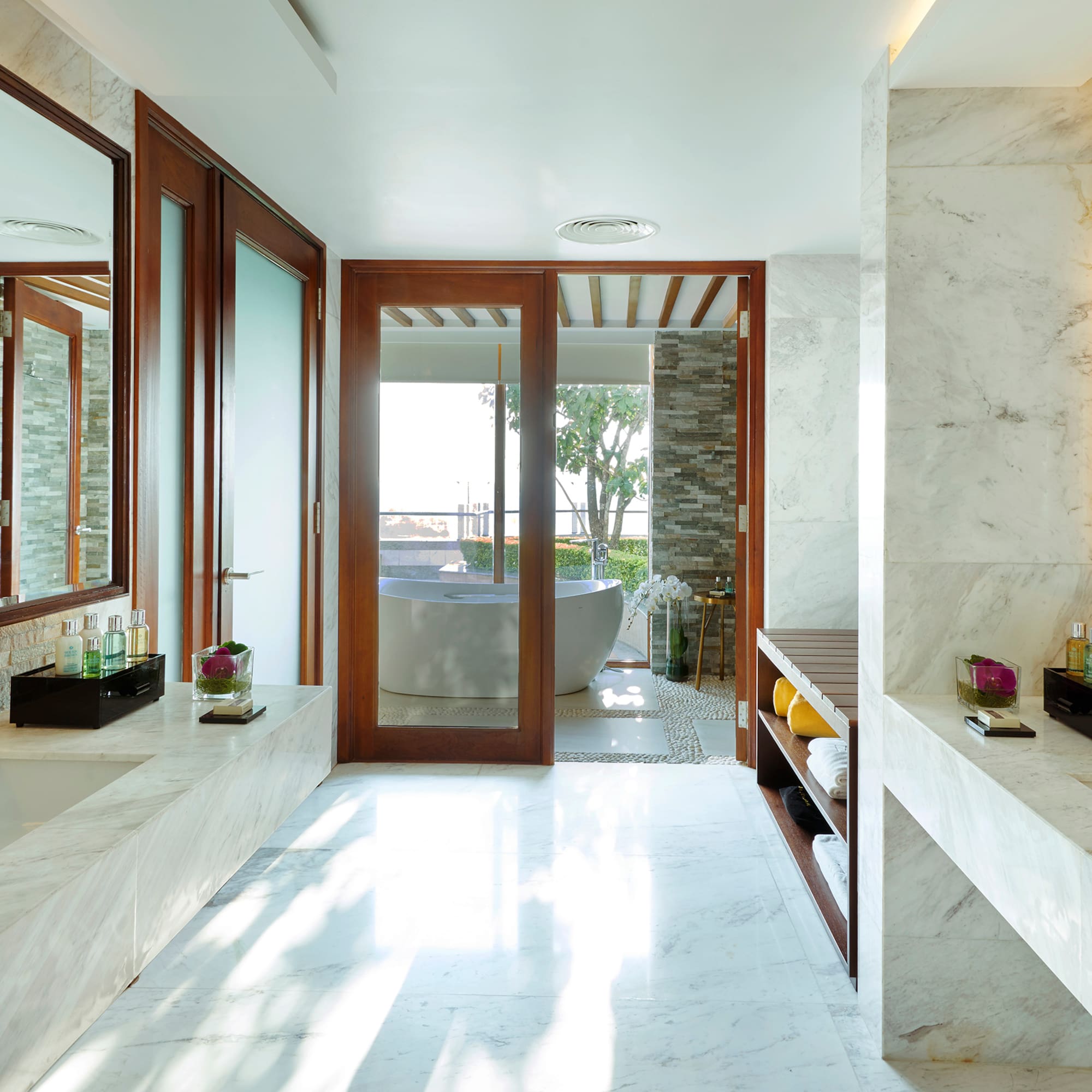 a bathroom with marble walls and a tub