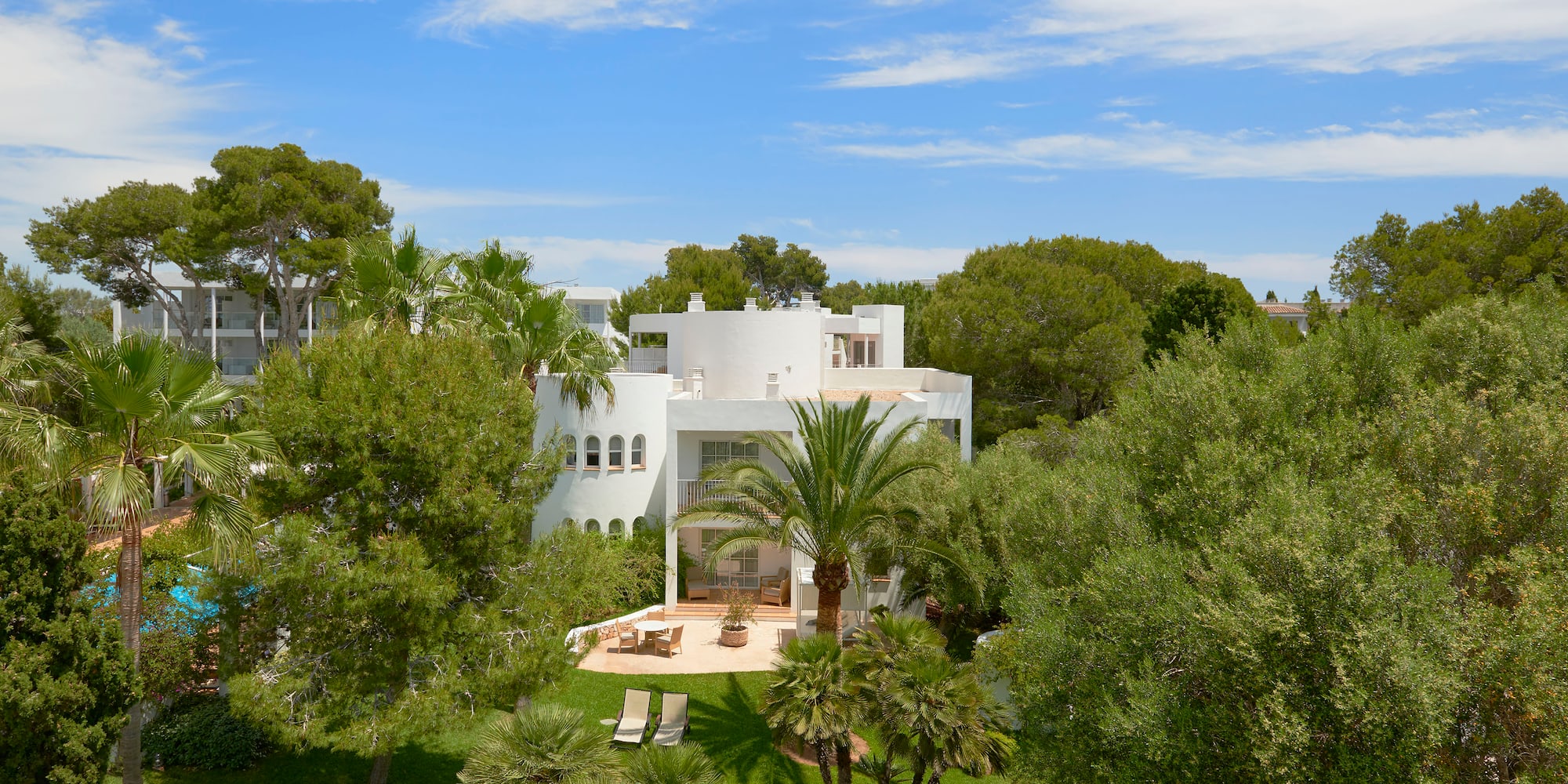 a white house surrounded by trees
