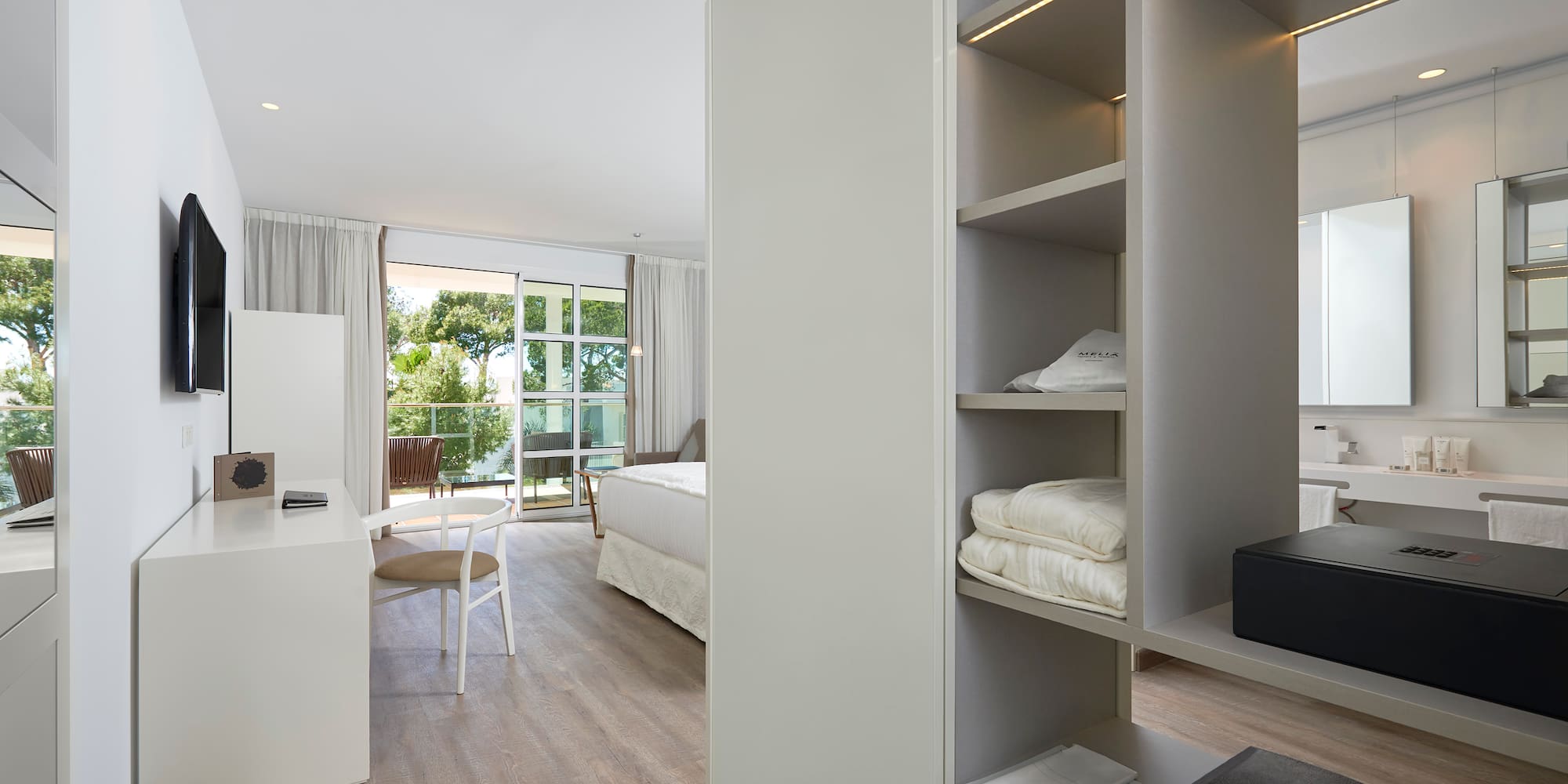 a room with a desk and shelves