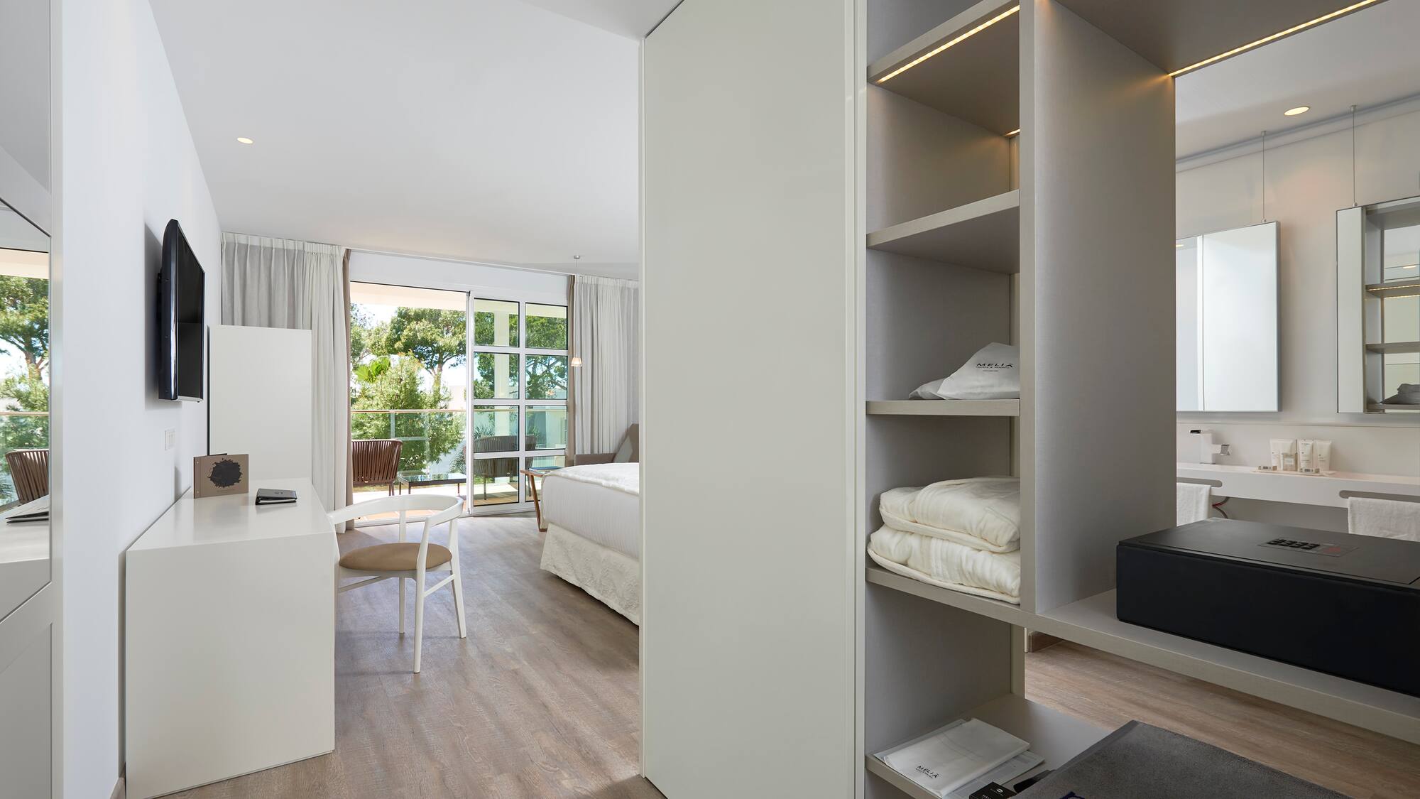 a room with a desk and shelves